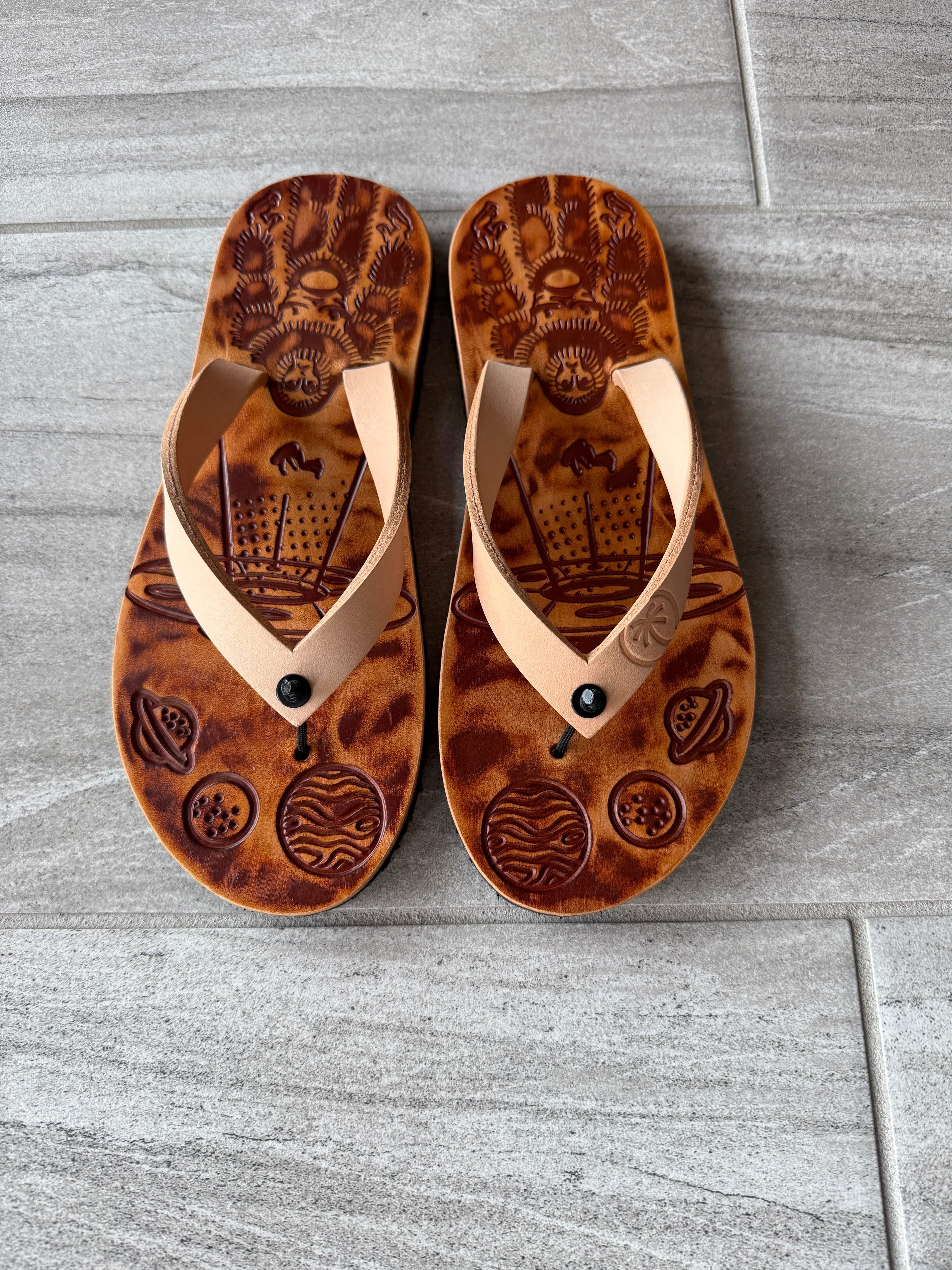 Toehold Bigfoot flip-flops with rugged strap design and textured soles, perfect for casual summer wear.