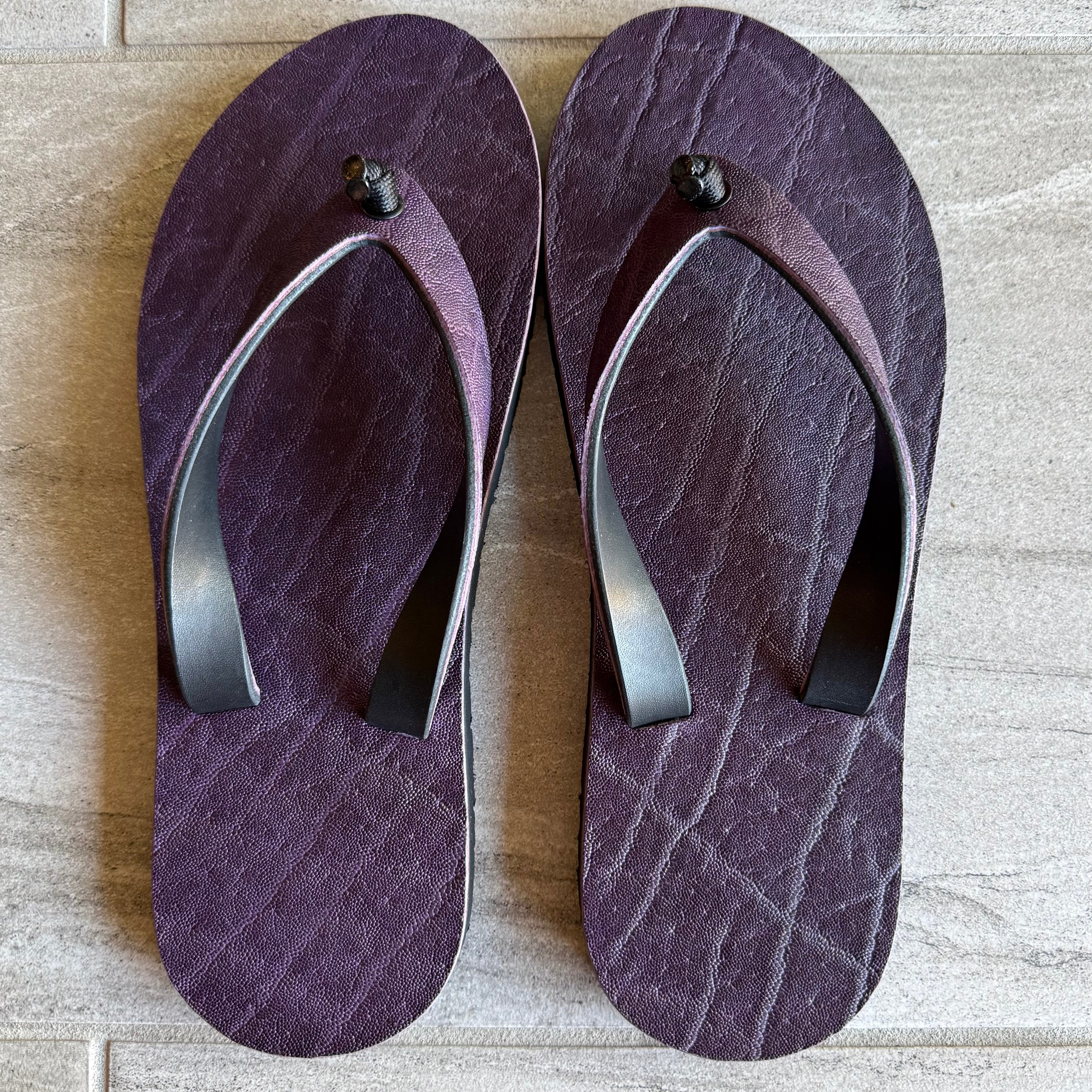 Purple Elephant Toehold flip-flops with elephant design featuring purple straps and sole, casual summer footwear.