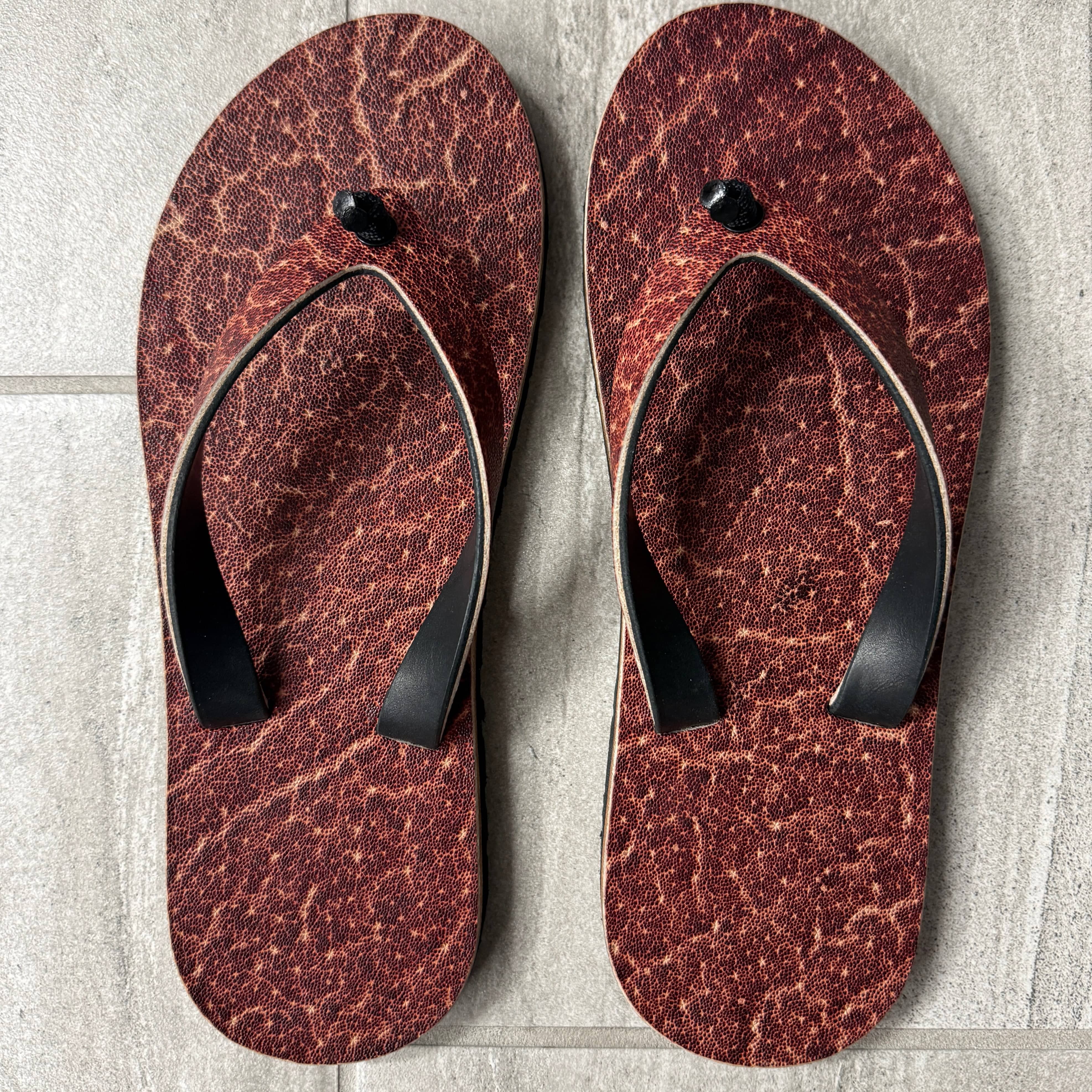 Toehold Man Killer Elephant flip-flops featuring bold elephant graphic and comfortable rubber straps.