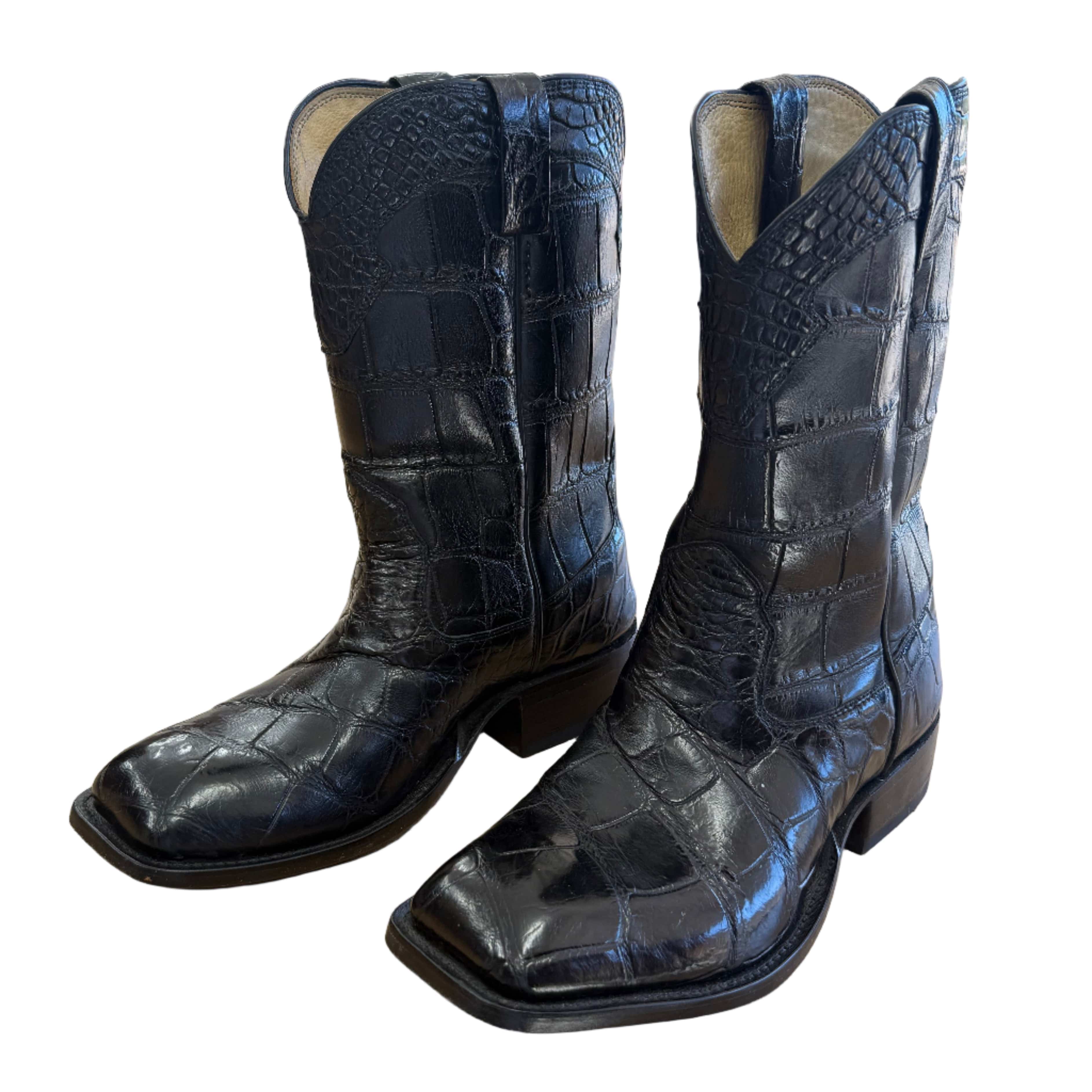 Black elephant cowboy boots by Toehold with pointed toes and decorative stitching, displayed on a neutral background.