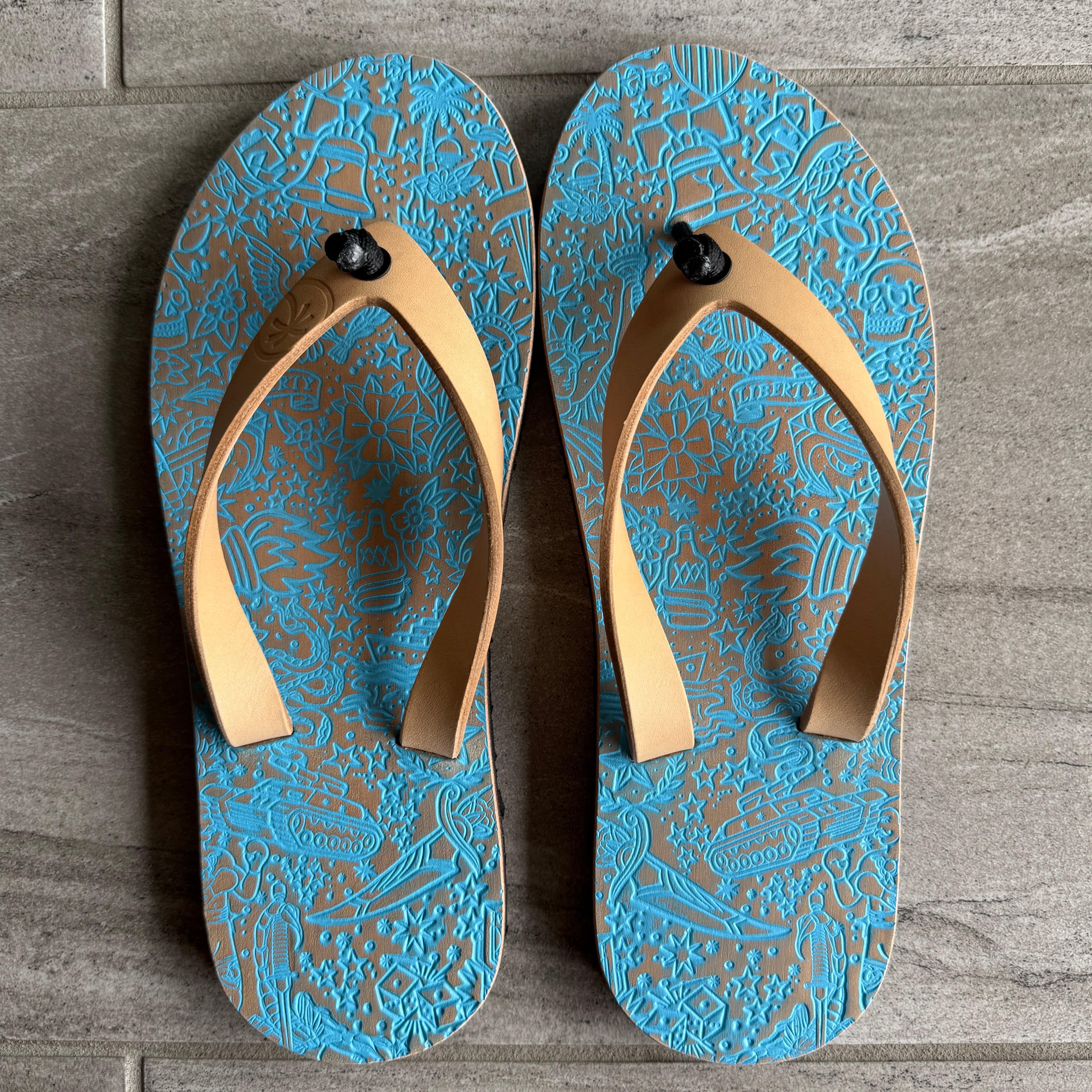 Toehold Freedom Flops flip-flops with black straps and cushioned soles, displayed on a neutral background.