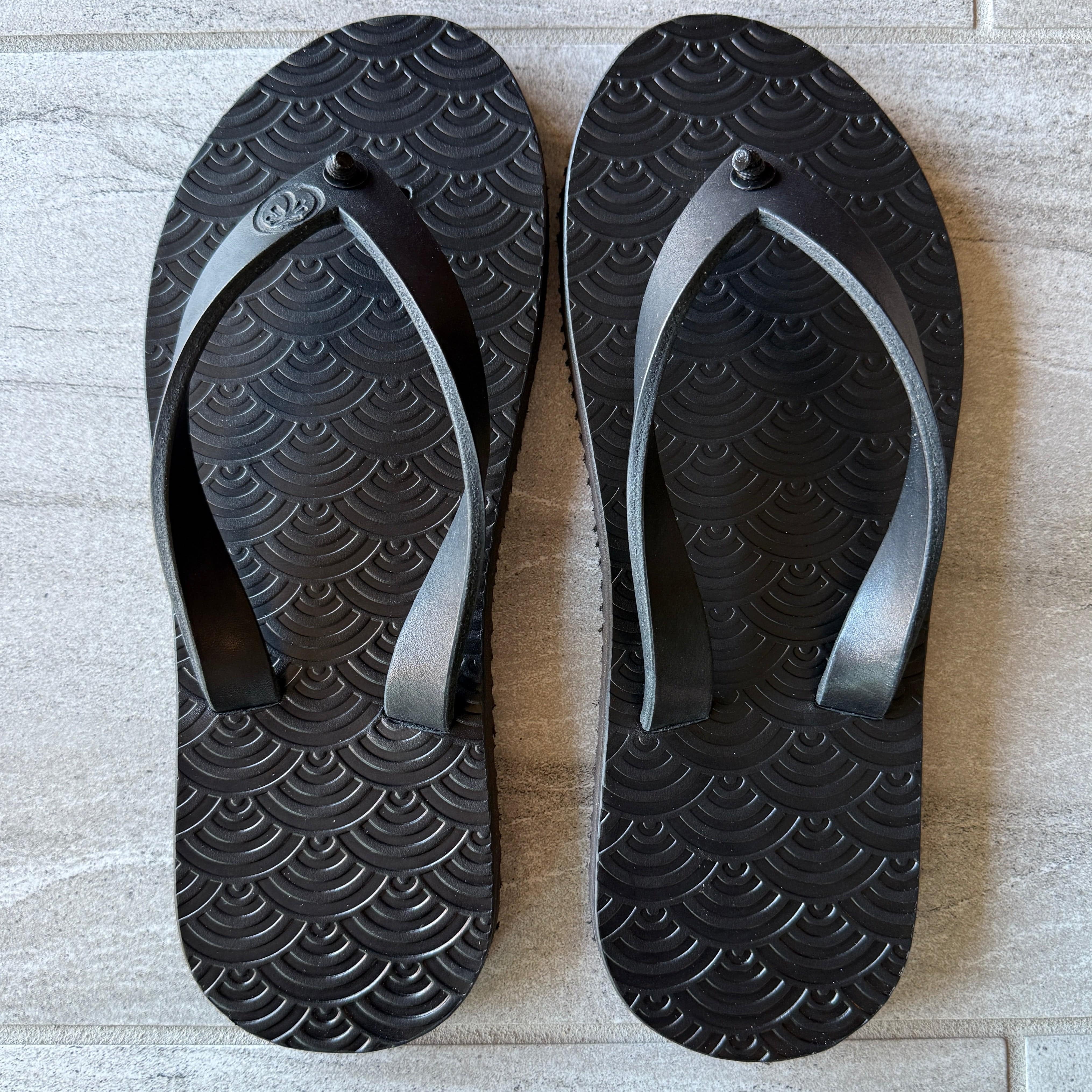 Black Samurai Armor flip-flops by Toehold featuring detailed armor design on the straps and comfortable sole.