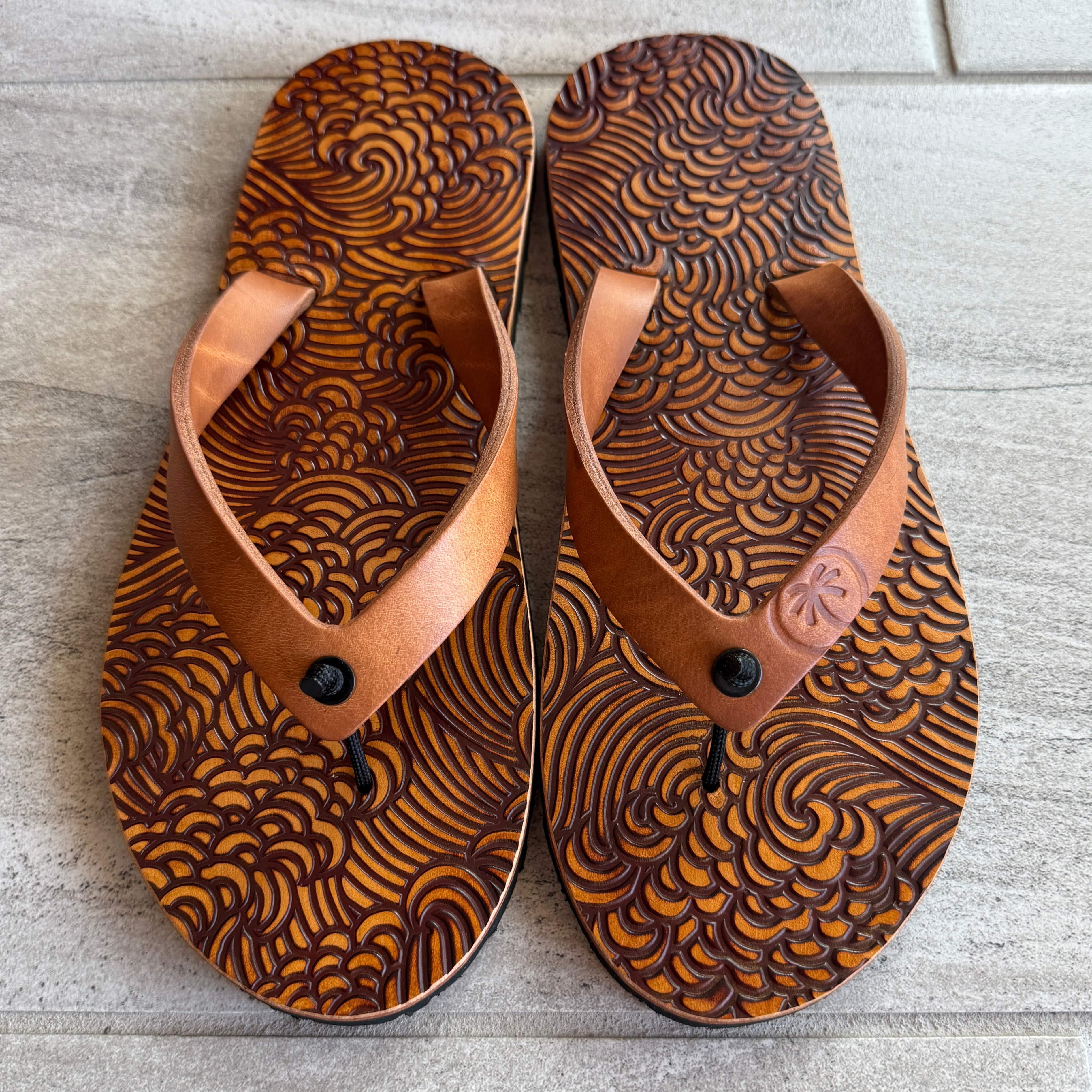 Toehold Storm flip-flops with black straps and textured sole, perfect for casual summer wear.