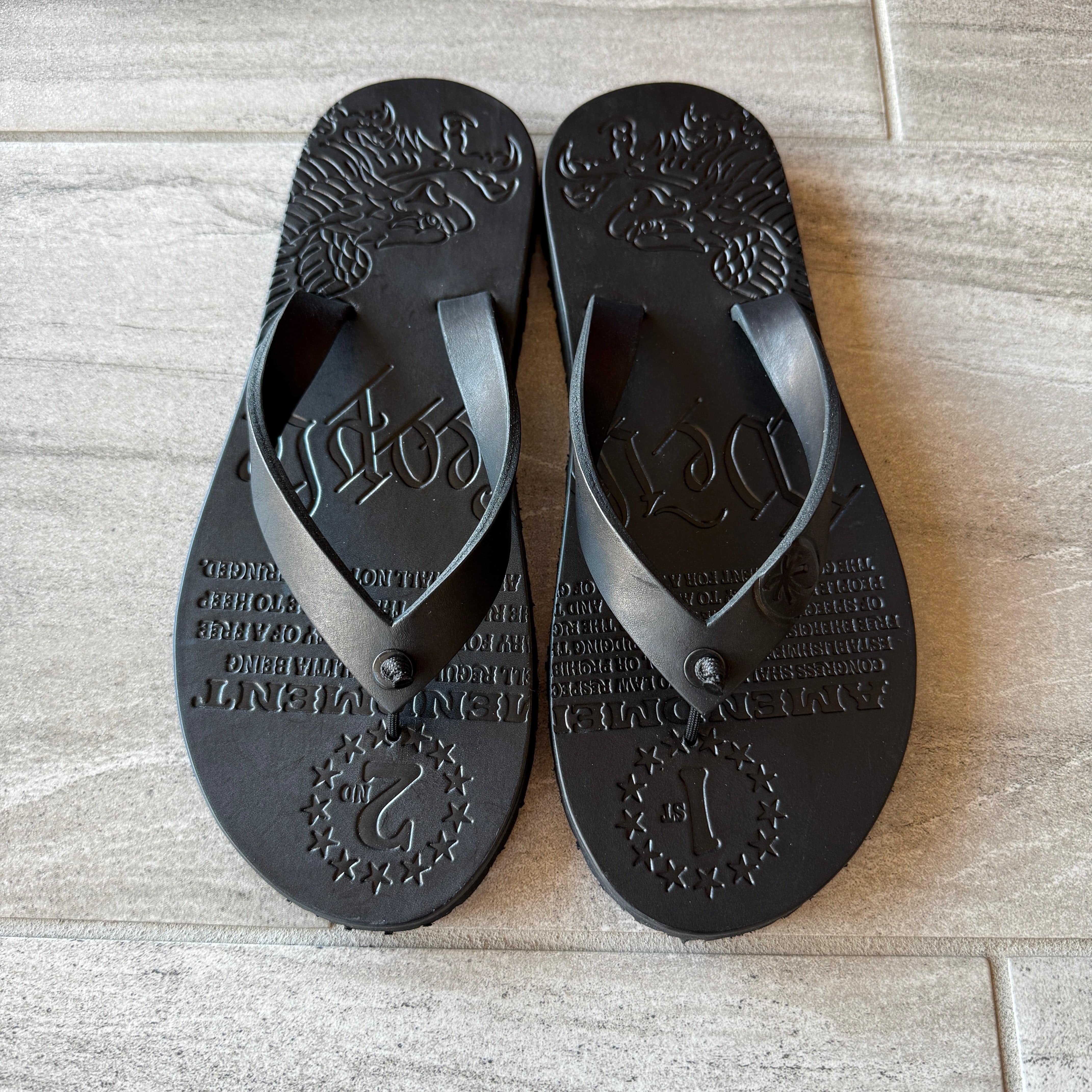 Black Toehold Patriot flip-flops with cushioned straps and textured soles, designed for comfortable casual wear.
