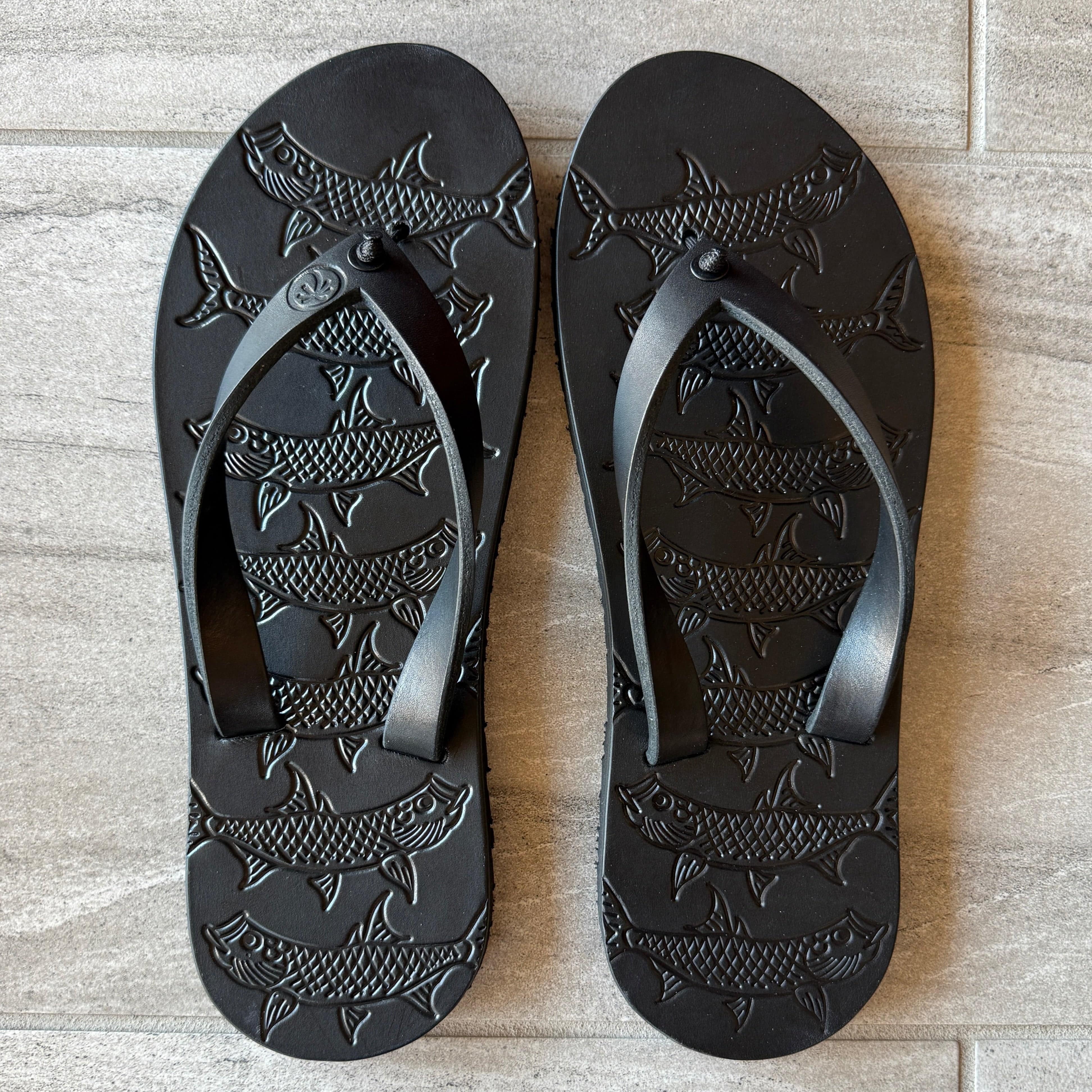 Black Toehold Tarpon flip-flops with cushioned straps and textured soles, shown on a white background.