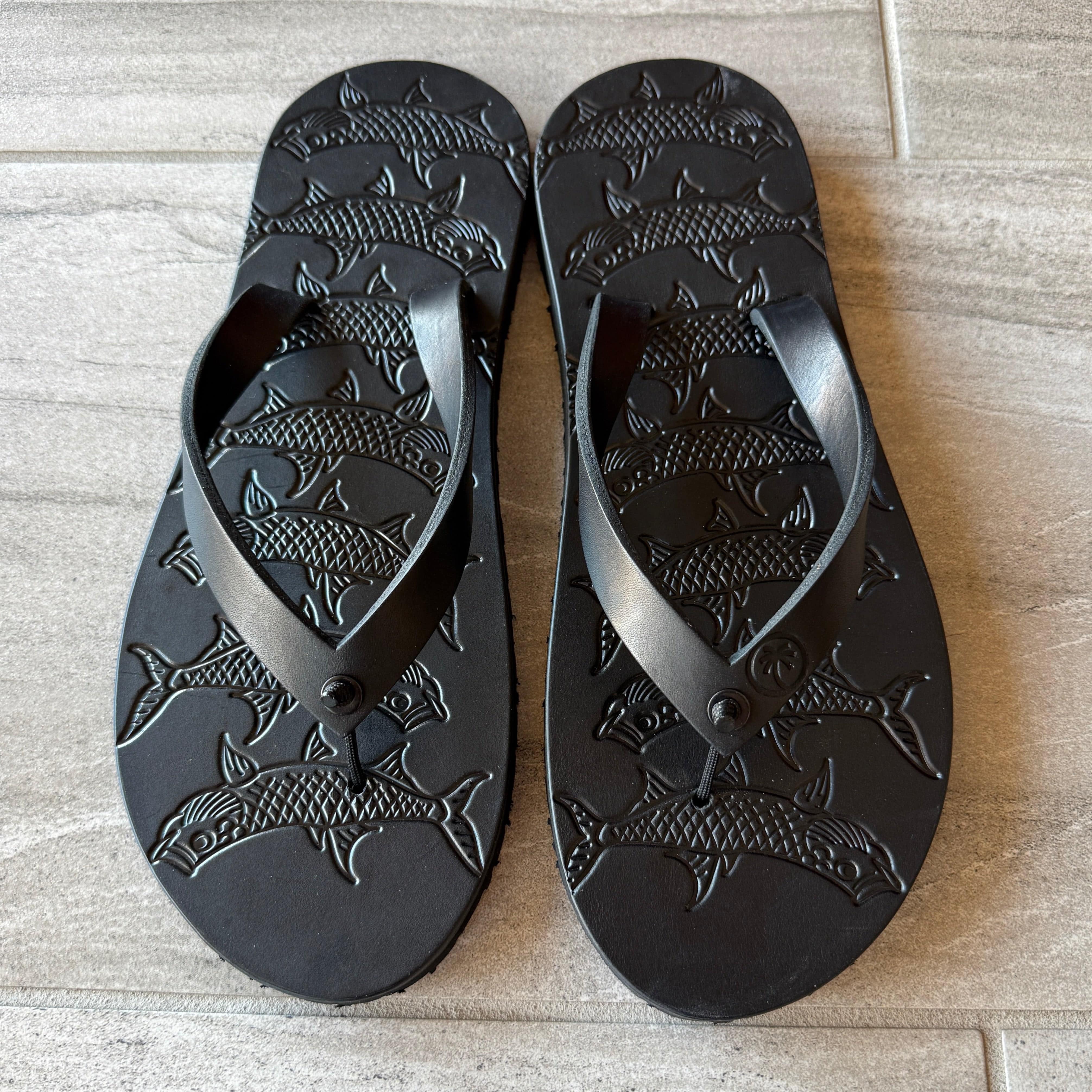 Black Tarpon flip-flops by Toehold with cushioned straps and textured soles, displayed on a white background.