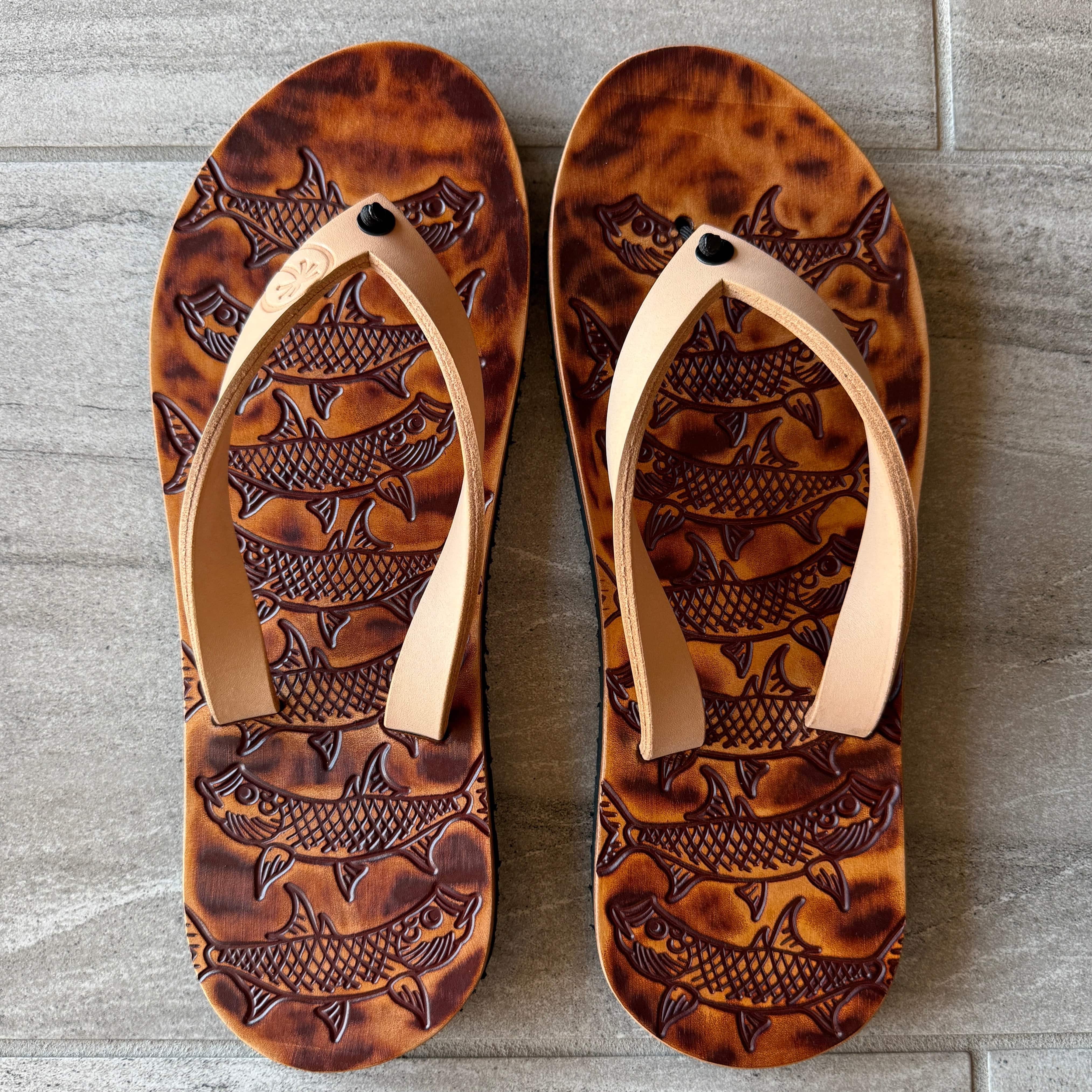 Toehold Tarpon flip-flops with black straps and textured sole, casual footwear for summer wear.