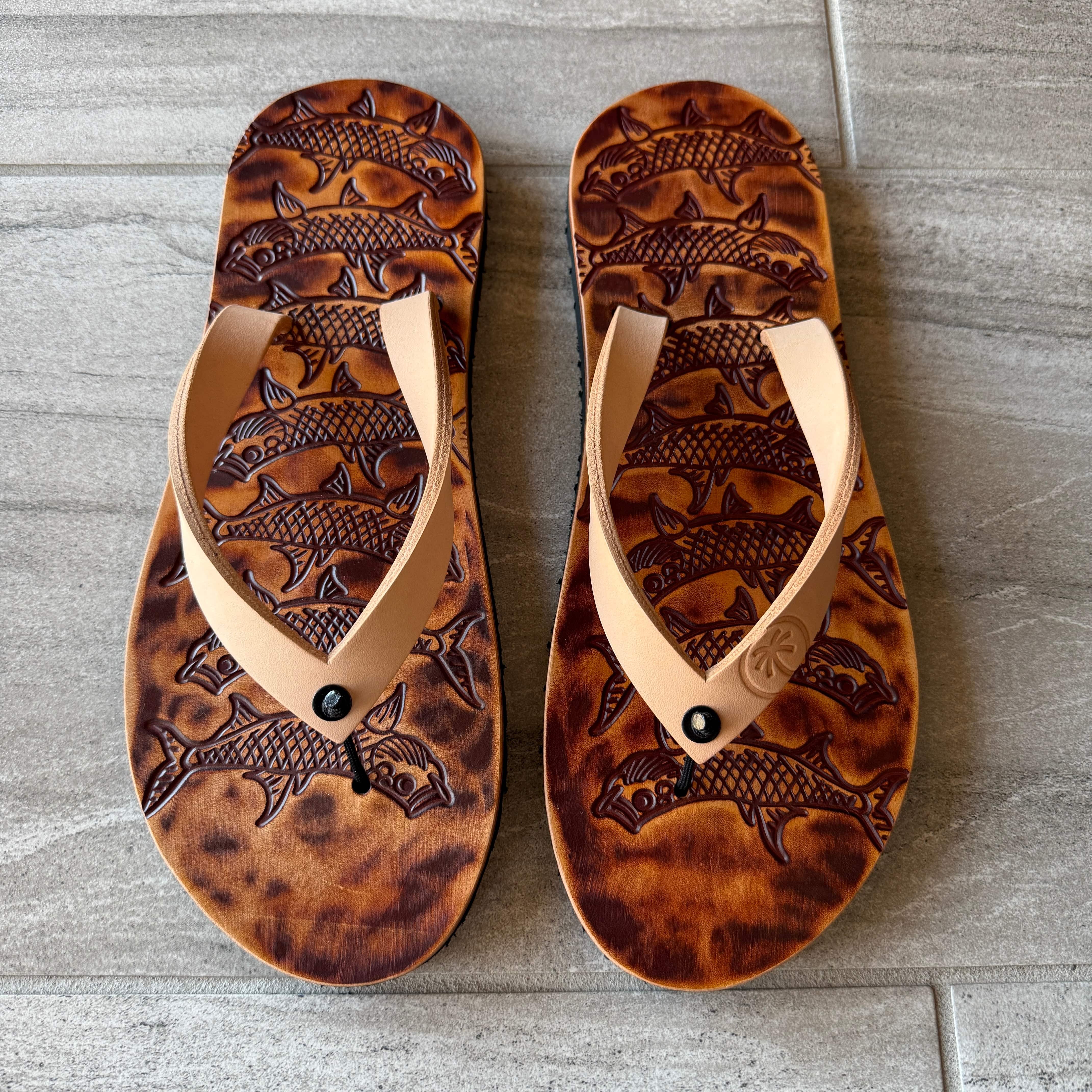 Toehold Tarpon flip-flops with black straps and textured soles, featuring a casual, comfortable design for everyday wear.