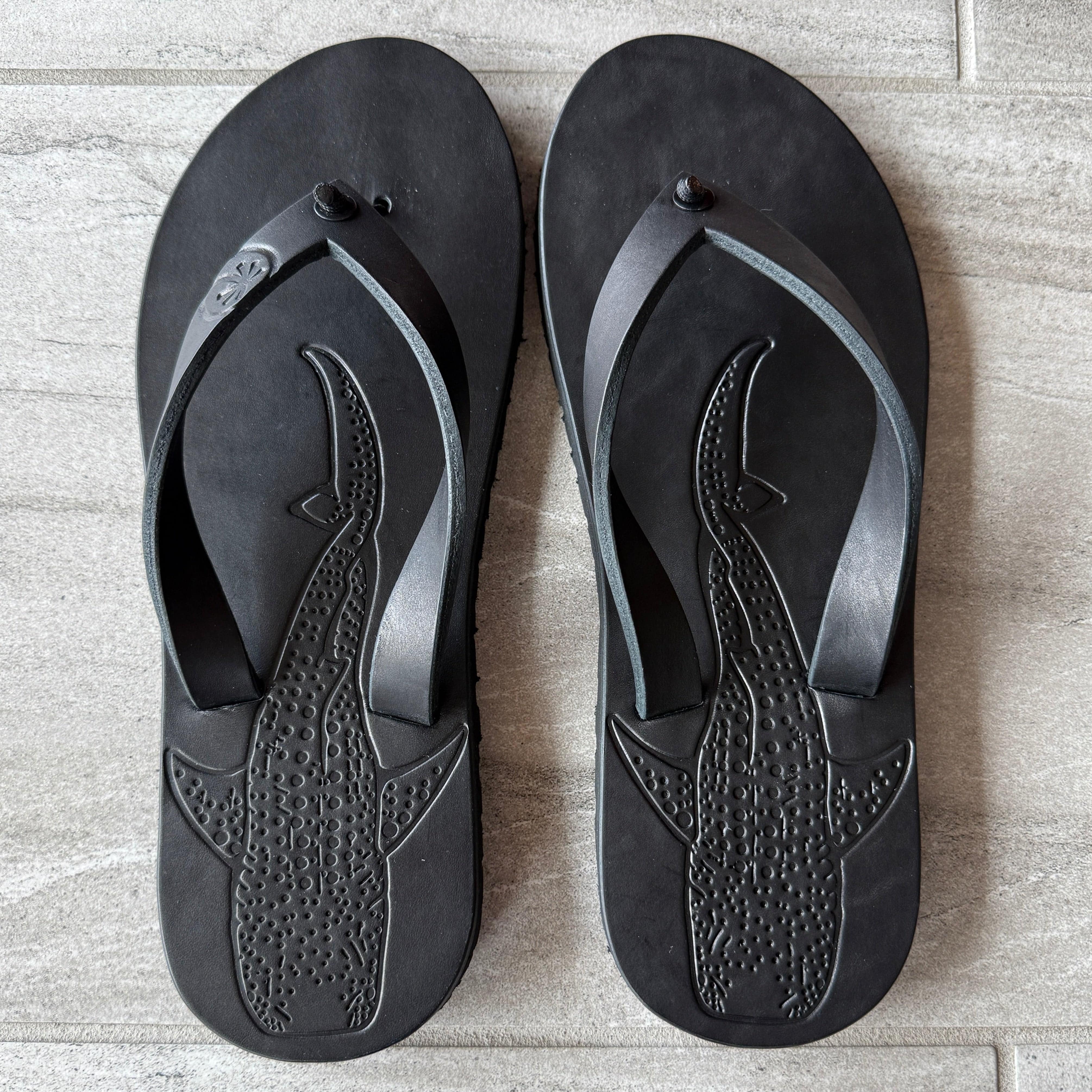 Toehold Whale Shark black flip-flops with shark design, featuring comfortable straps and casual summer footwear style.