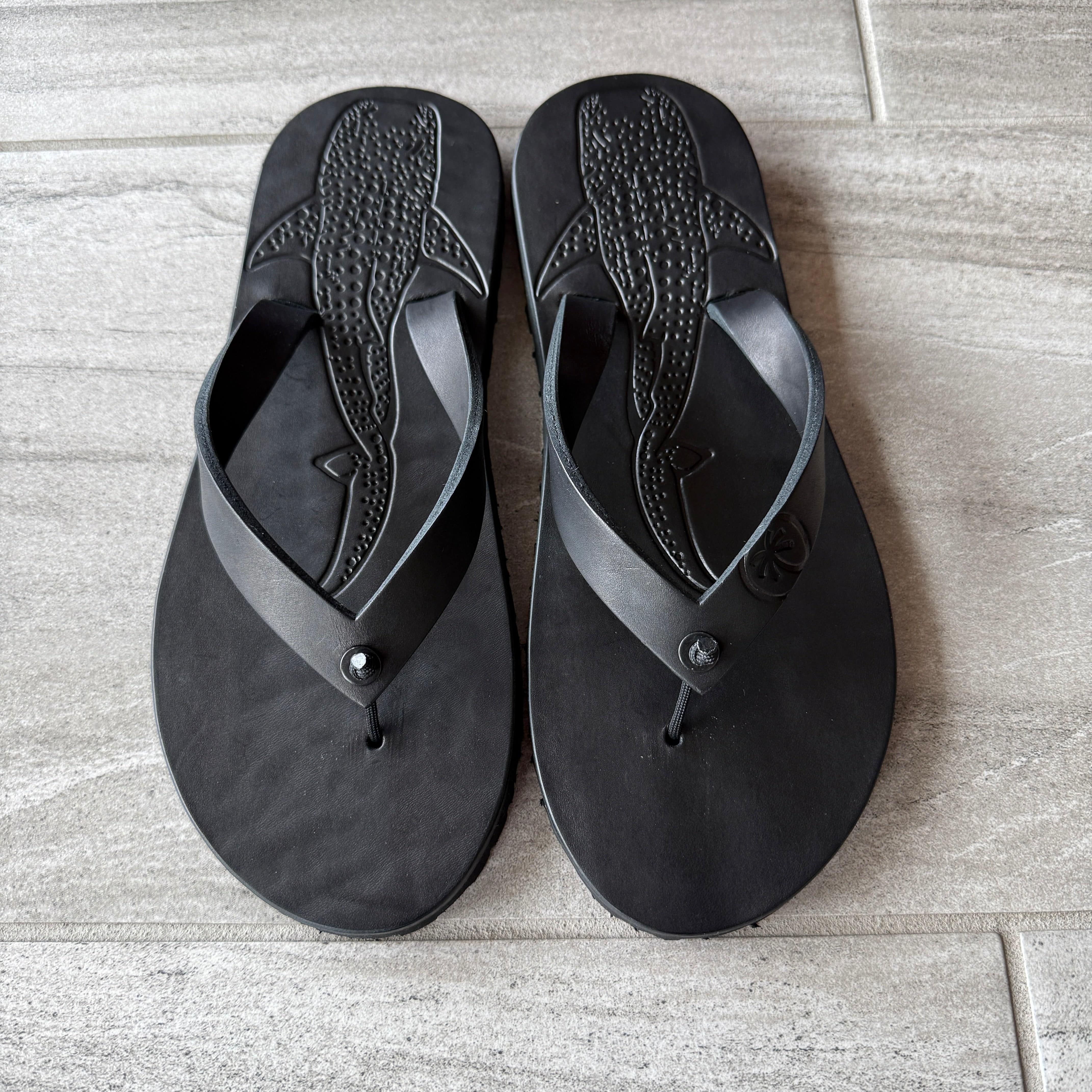 Toehold Whale Shark black flip-flops with whale shark design and comfortable straps, perfect for casual wear.