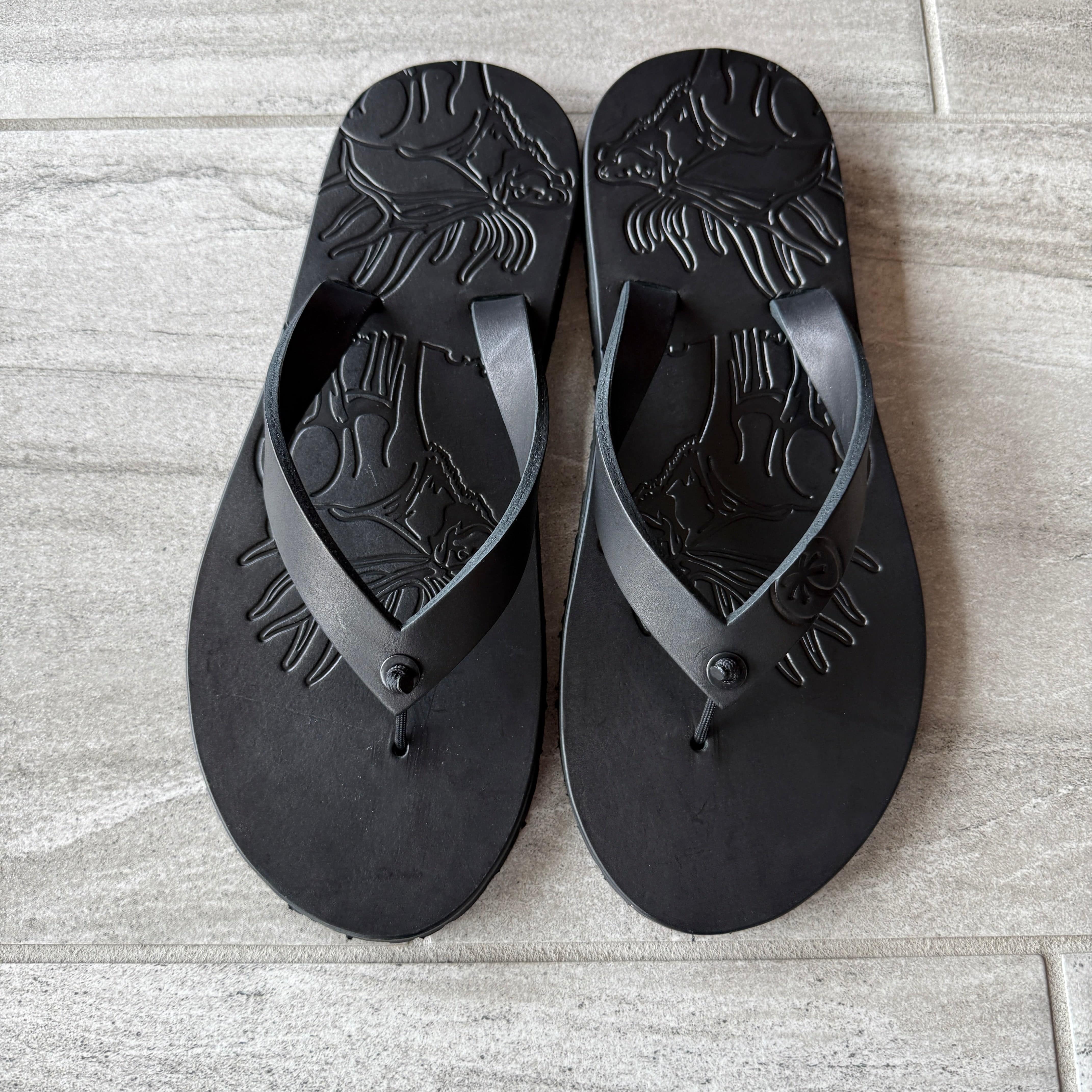 Black Bull Elk flip-flops by Toehold featuring a detailed elk design on comfortable rubber straps.