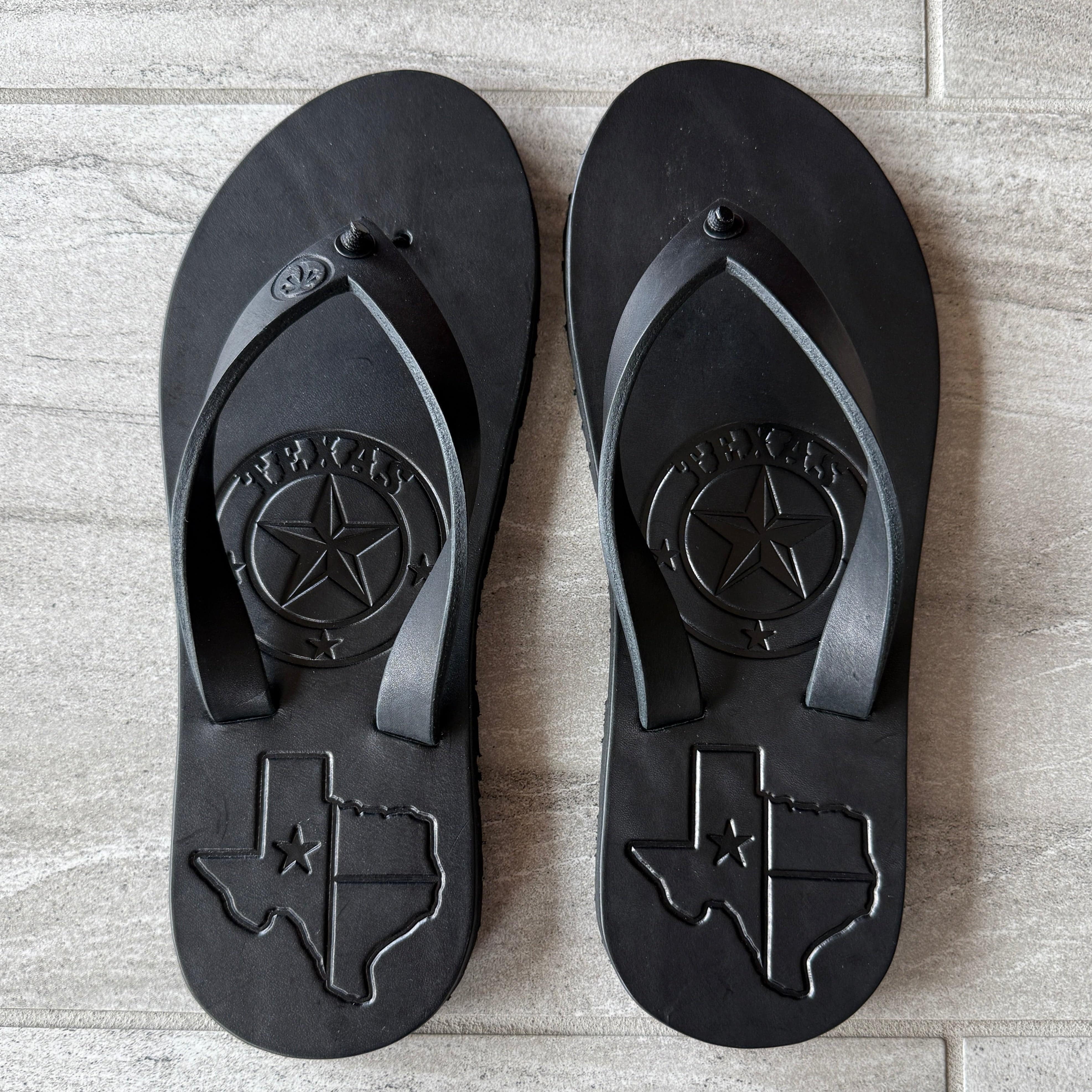 Black Toehold "Texas" flip-flops with cushioned straps and textured soles, suitable for casual wear.