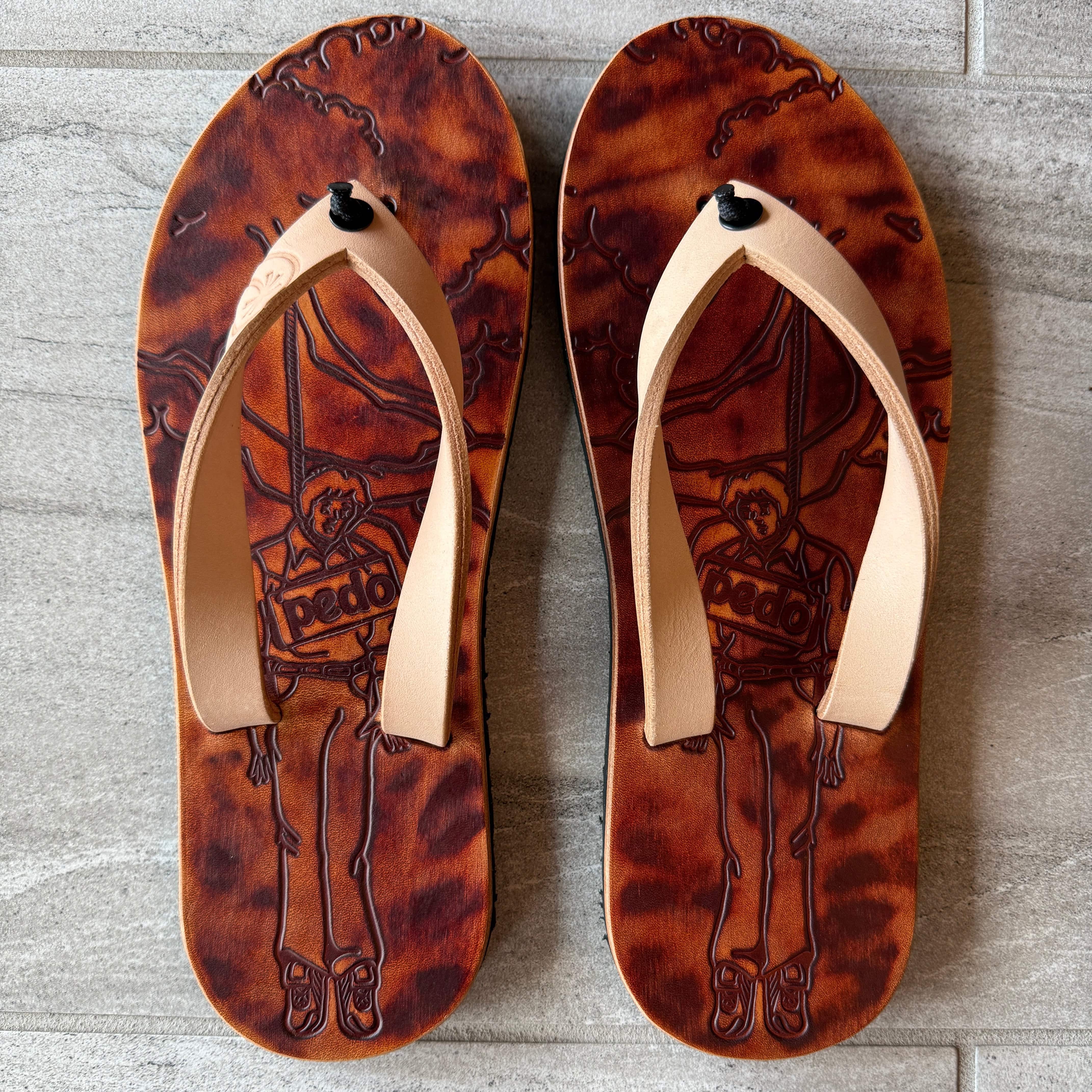 Toehold Pedo Hunter flip-flops with black straps and cushioned soles, displayed on a plain background.