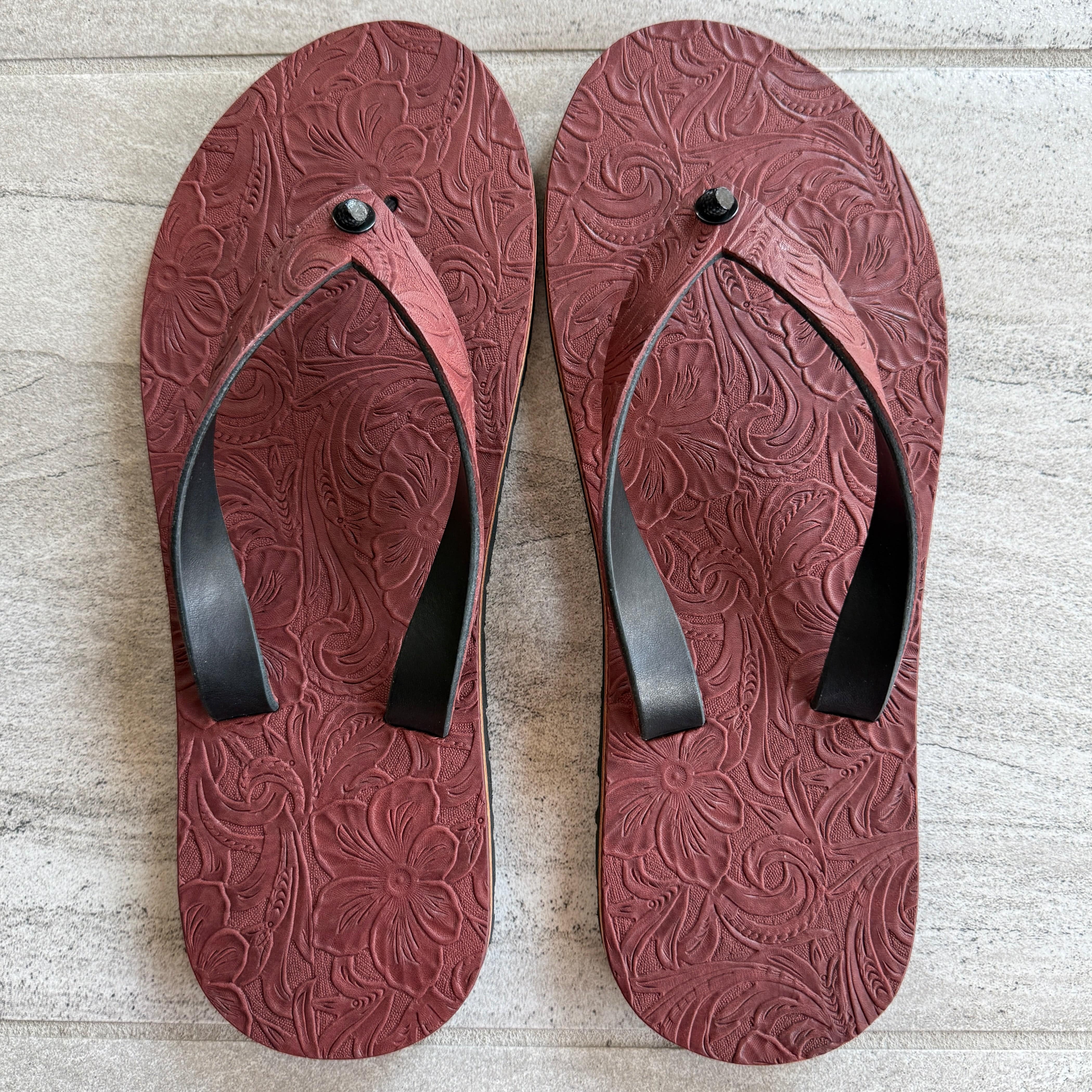 Toehold Diablo Rose flip-flops featuring floral rose pattern on black straps and comfortable sole for casual wear.