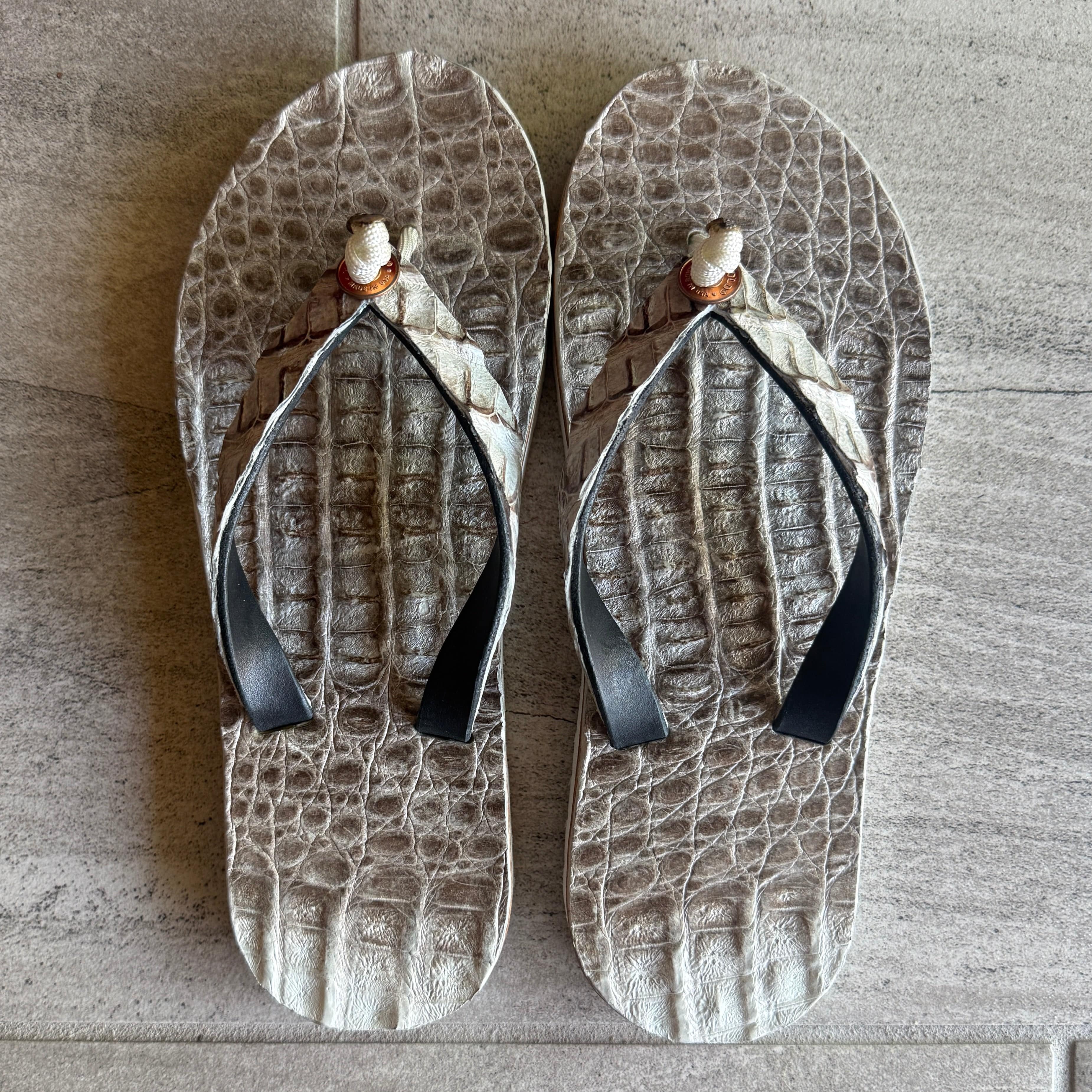 Himalayan Crocodile flip-flops by Toehold featuring a realistic crocodile design on black rubber soles.