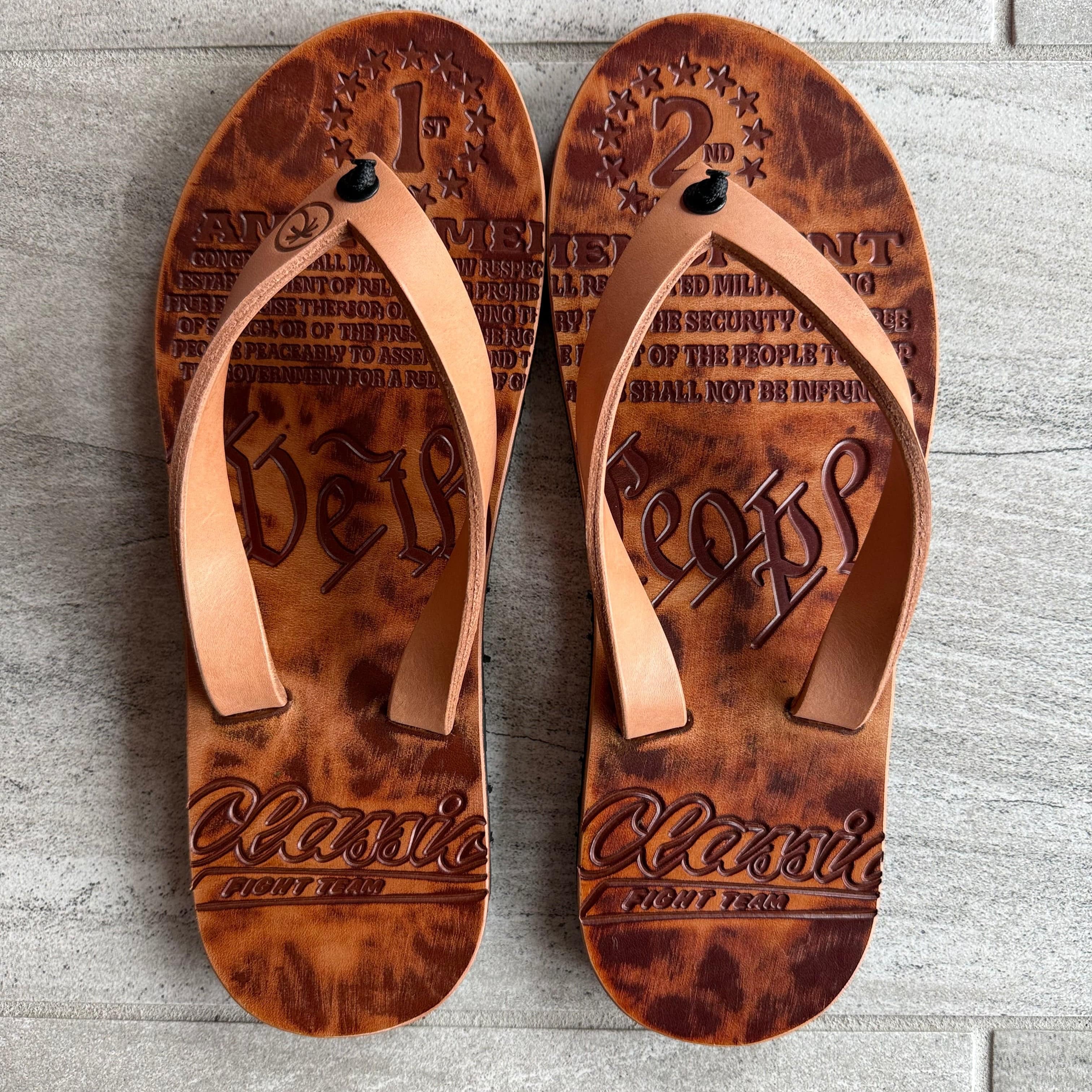 Men's Toehold CFT RTS flip-flops in size 11-12, featuring black straps and cushioned soles, displayed on a plain background.