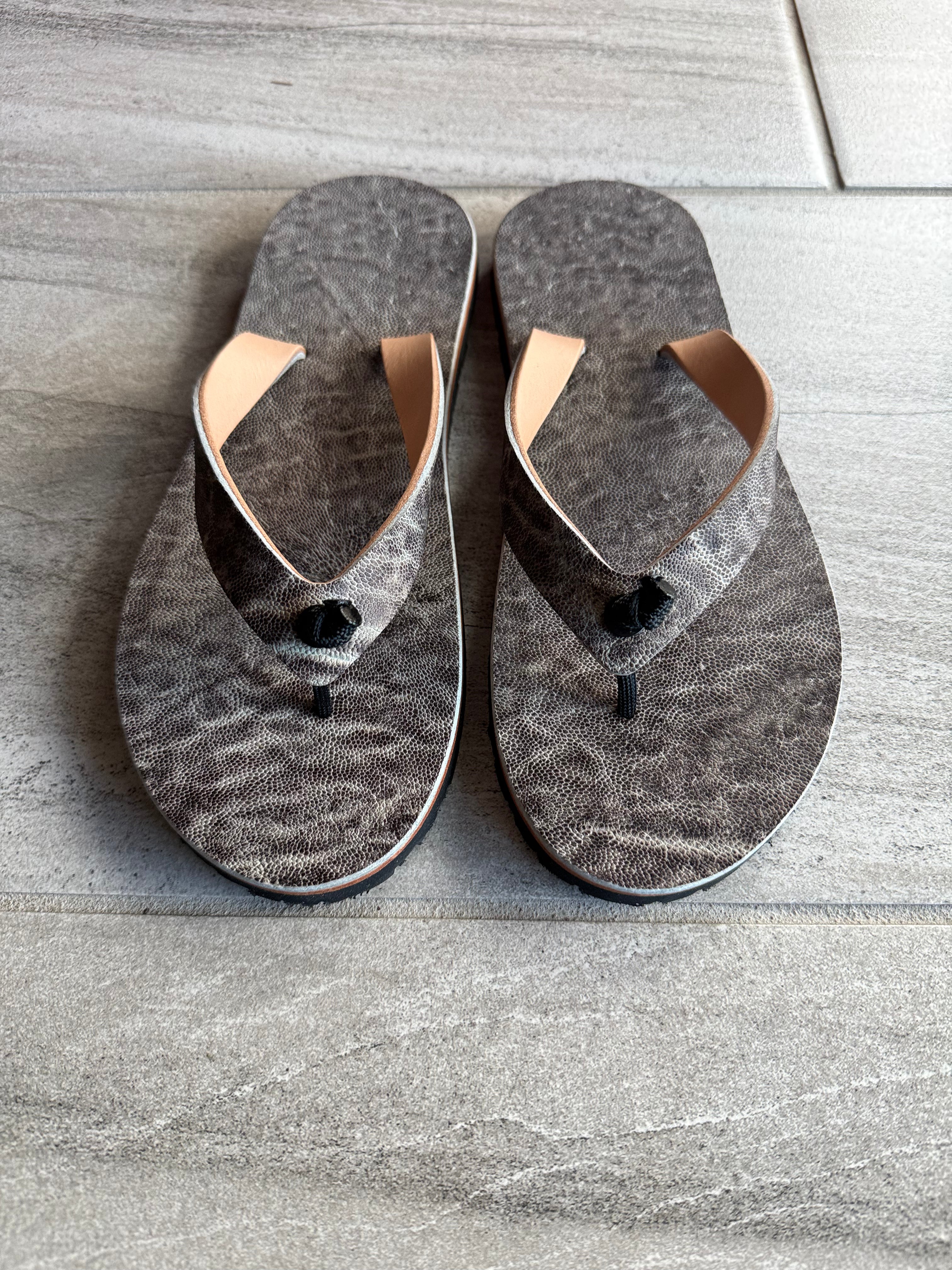 Toehold Ghost Elephant flip-flops featuring a ghostly elephant design on comfortable rubber soles.