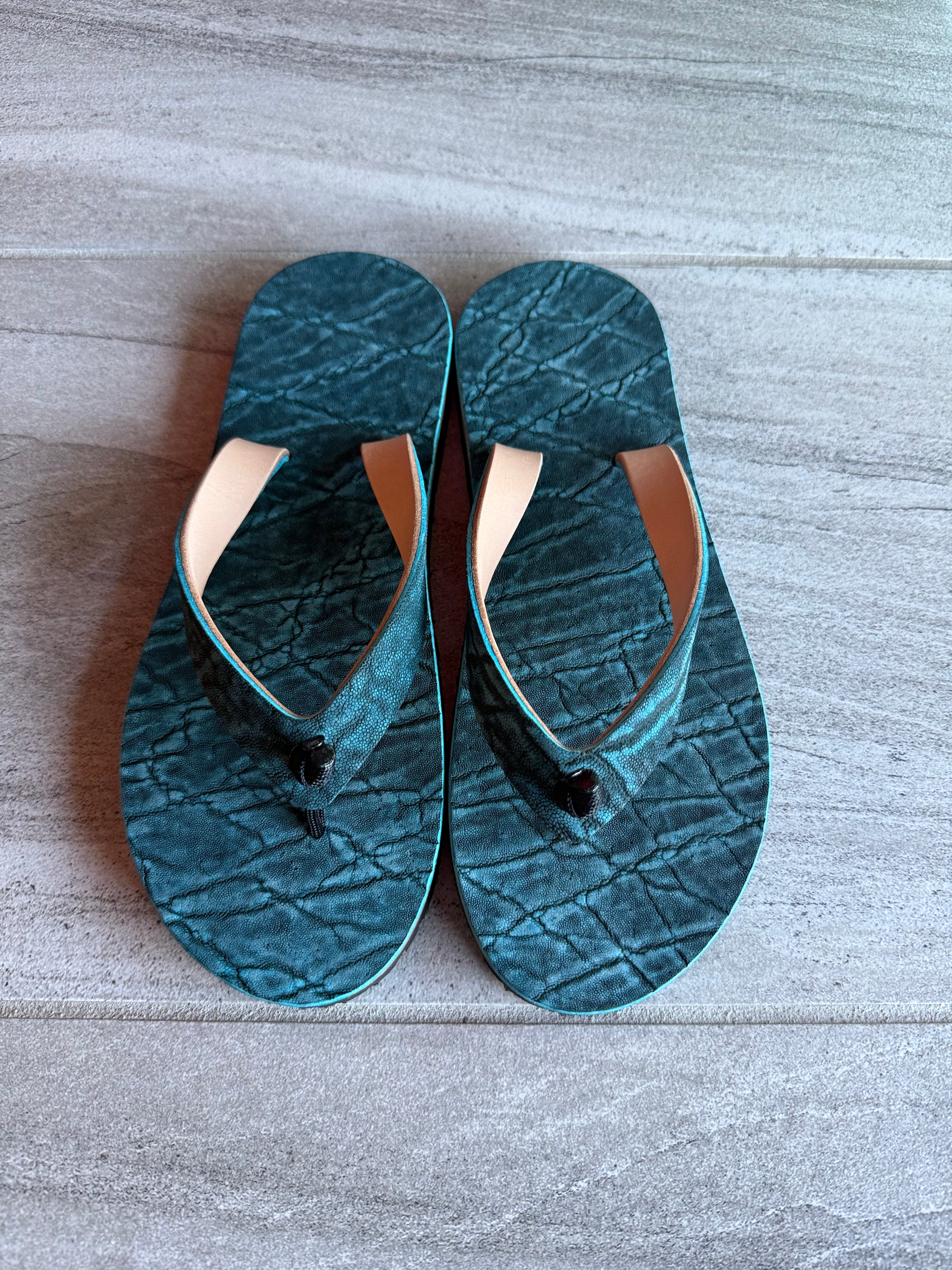 Toehold South African Elephant flip-flops with elephant design and colorful straps on a white background