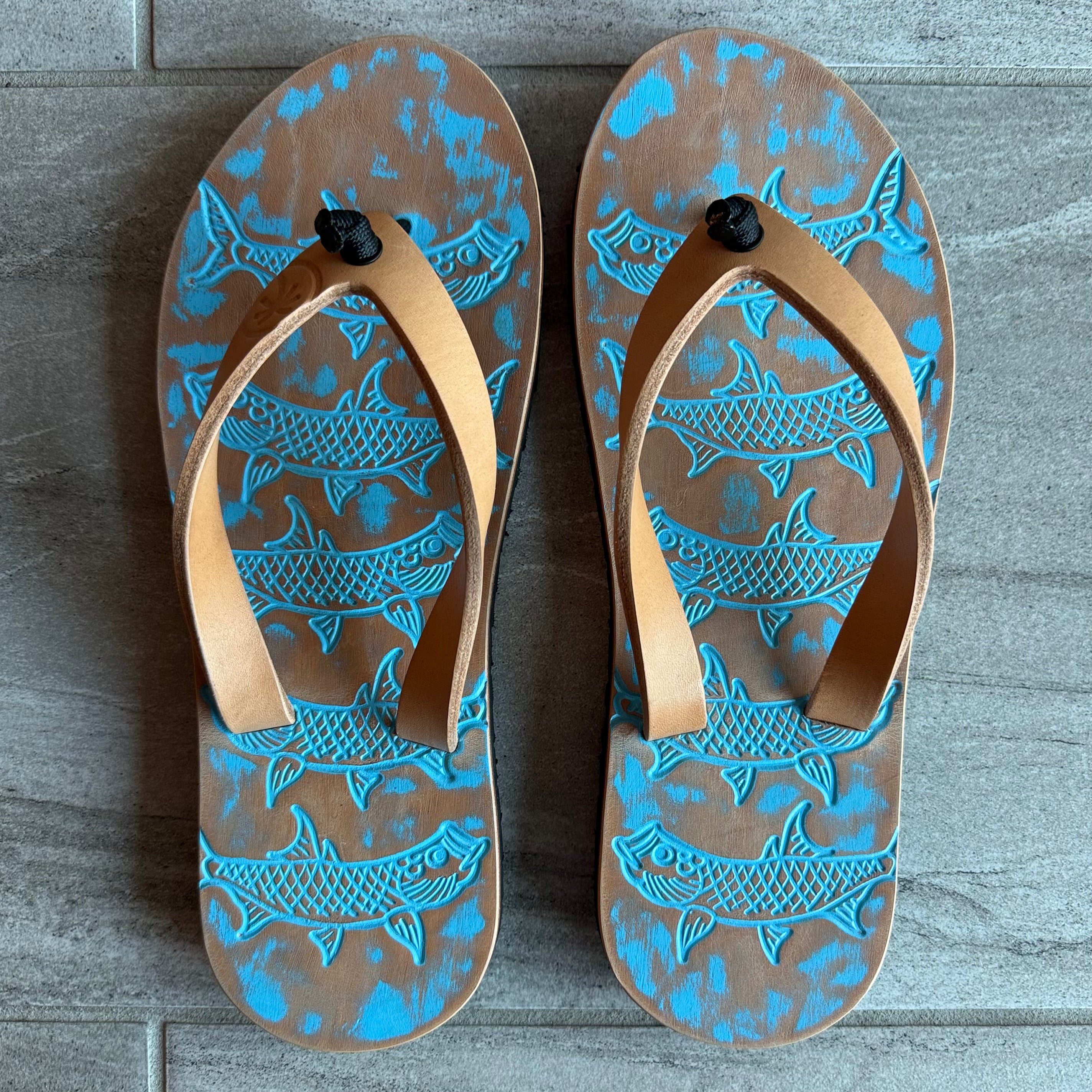 Pale blue Toehold Tarpon flip-flops with cushioned straps and textured soles, suitable for casual summer wear.