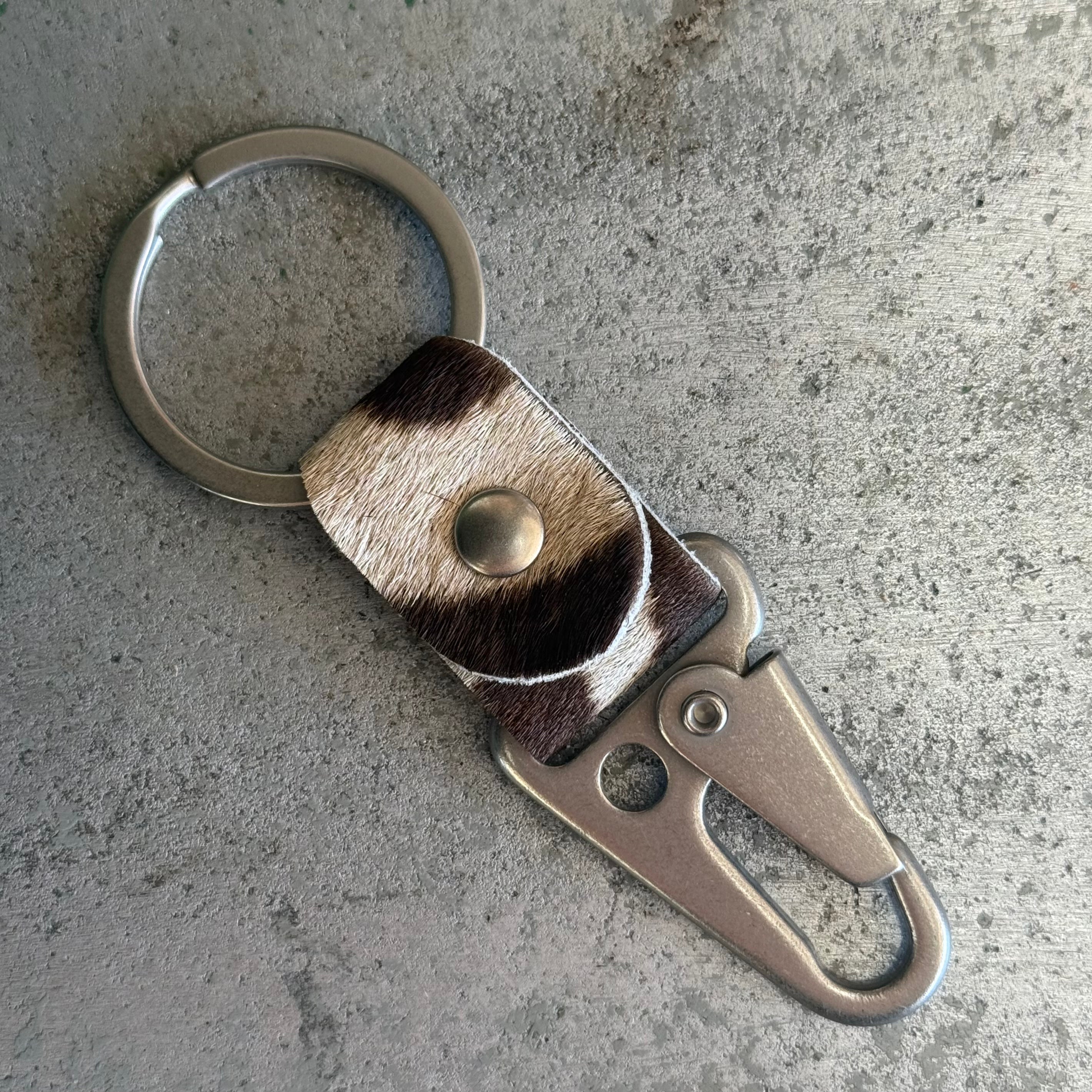 Toehold zebra key fob with black and white striped design on a metal keyring.