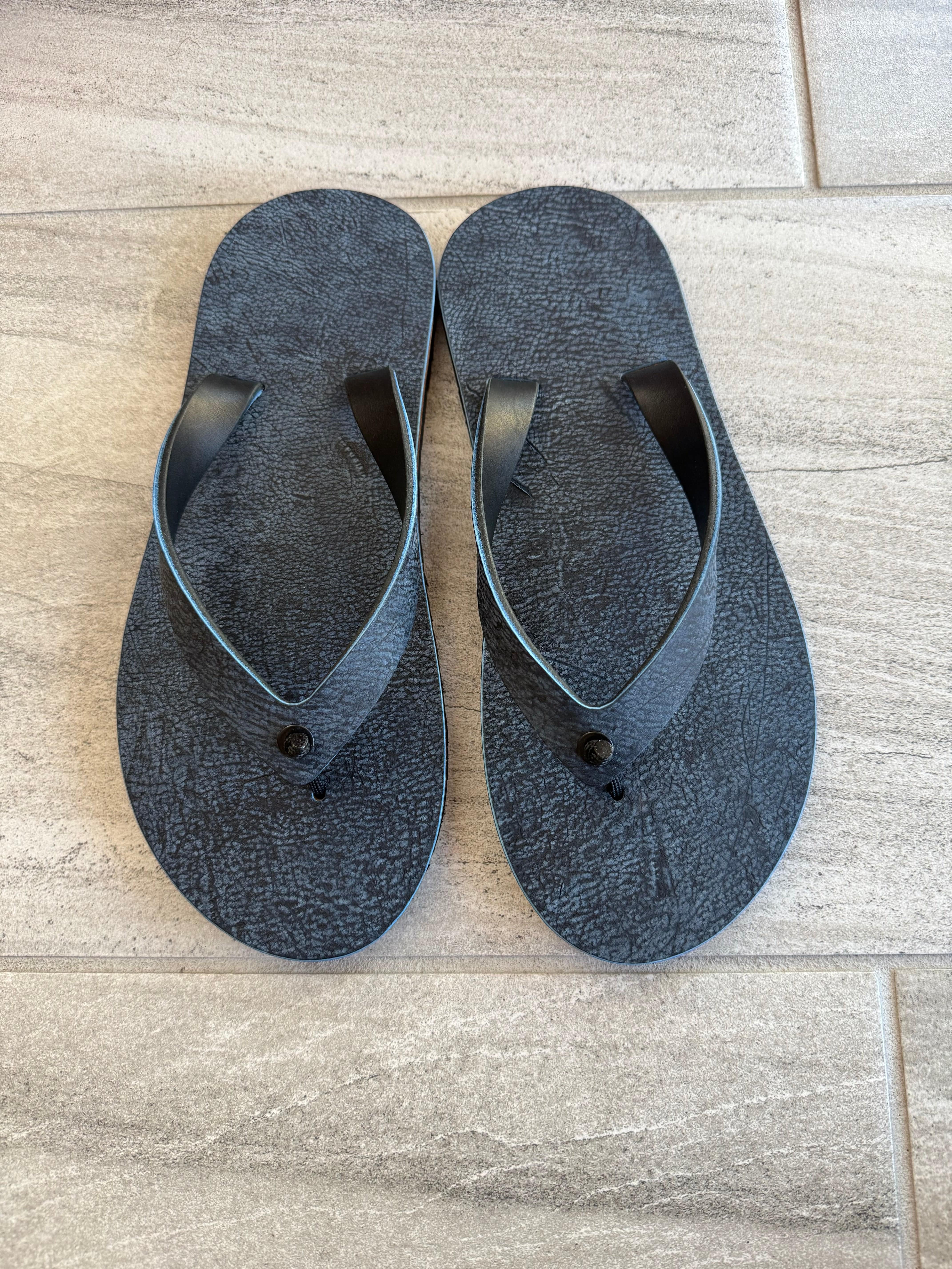 Blue Giraffe flip-flops by Toehold featuring a playful giraffe design and comfortable rubber soles.