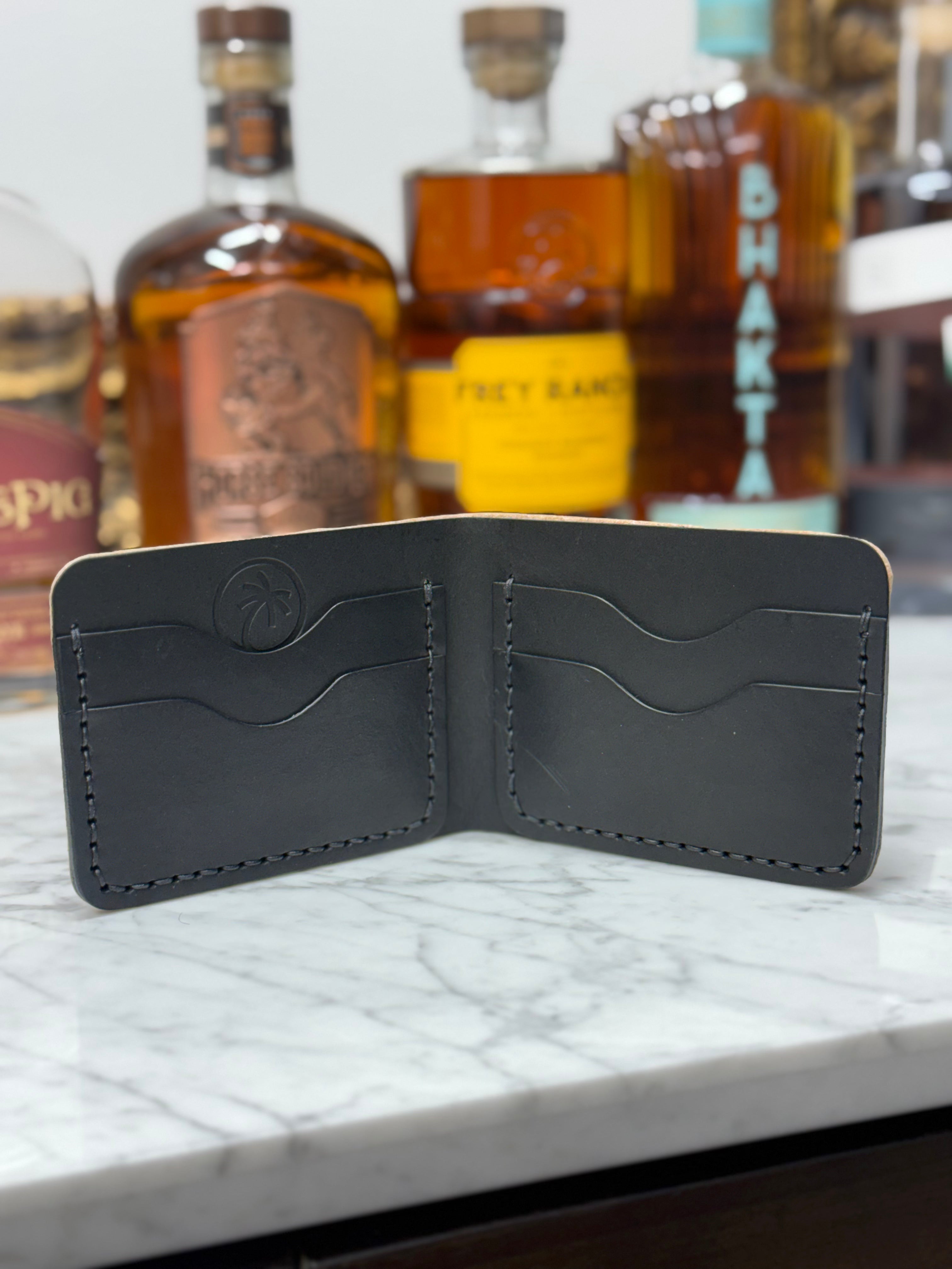 Toehold man’s bi-fold wallet featuring an embossed elephant design, crafted from durable leather for everyday use.