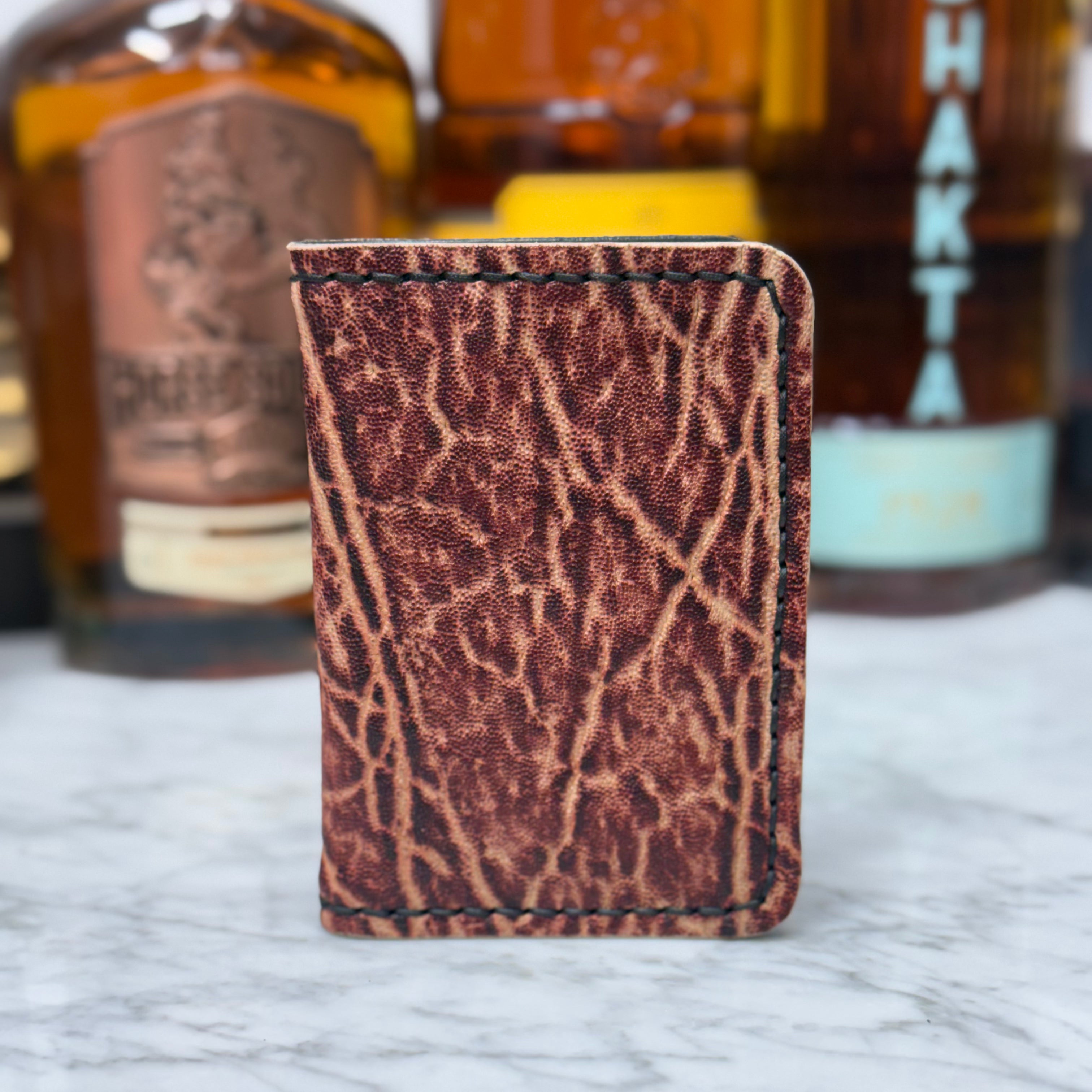 Toehold Man Killing Elephant JW Wallet with detailed embossed elephant and intricate design on leather surface.