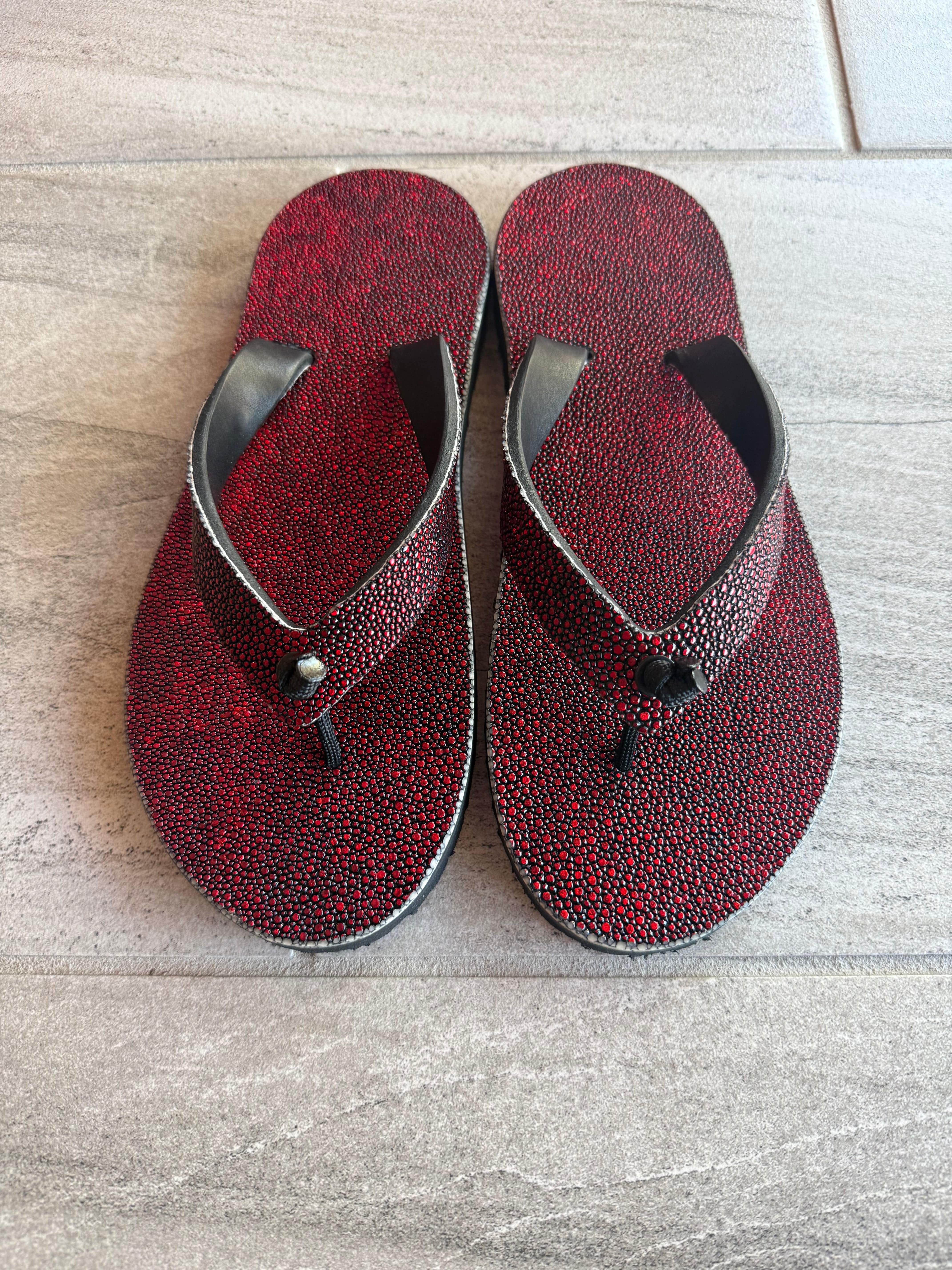 Toehold Vampire Stingray flip-flops with black and white design and adjustable straps, displayed on a plain background.