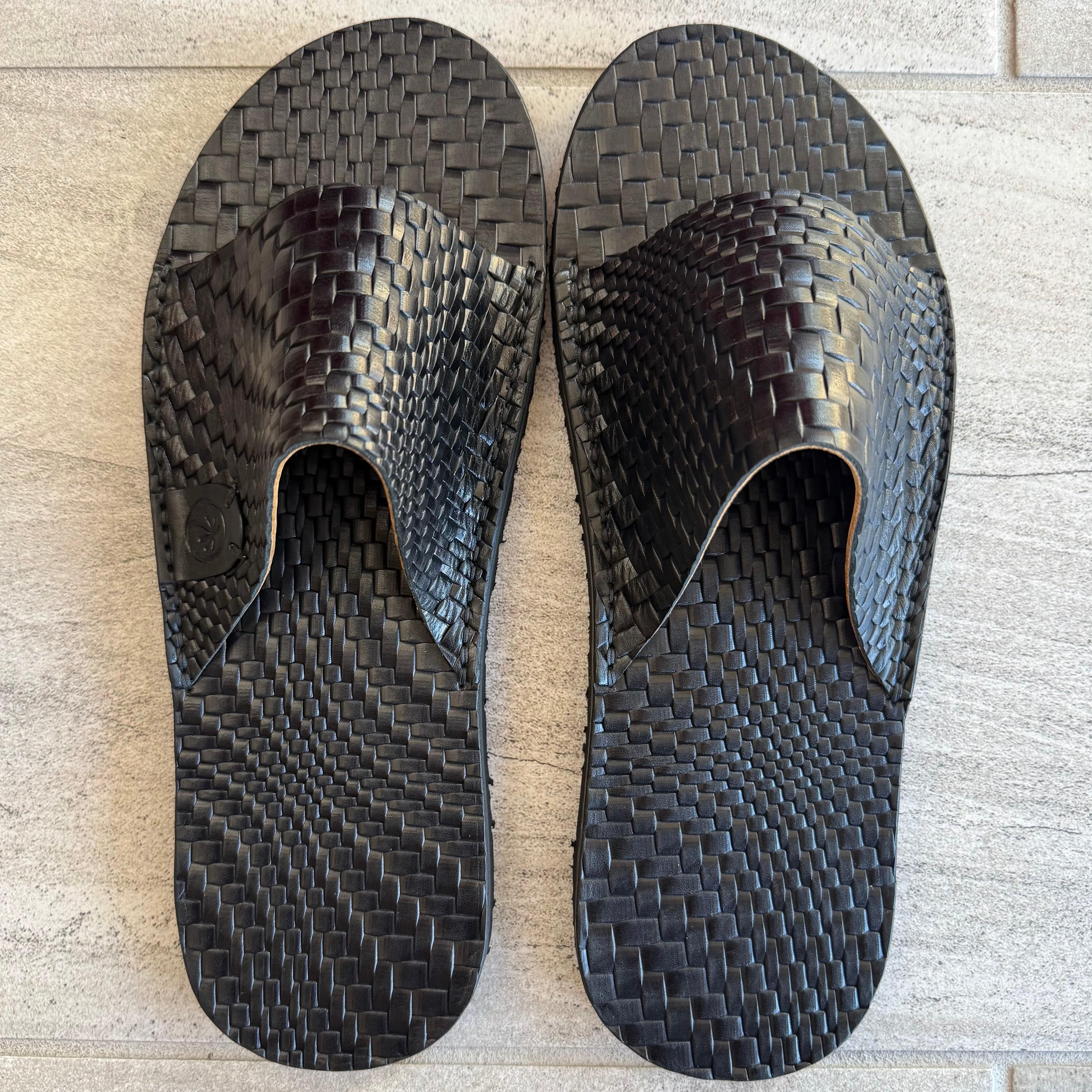 Black grenade flip-flops by Toehold featuring bold grenade graphic design and comfortable slip-on style.