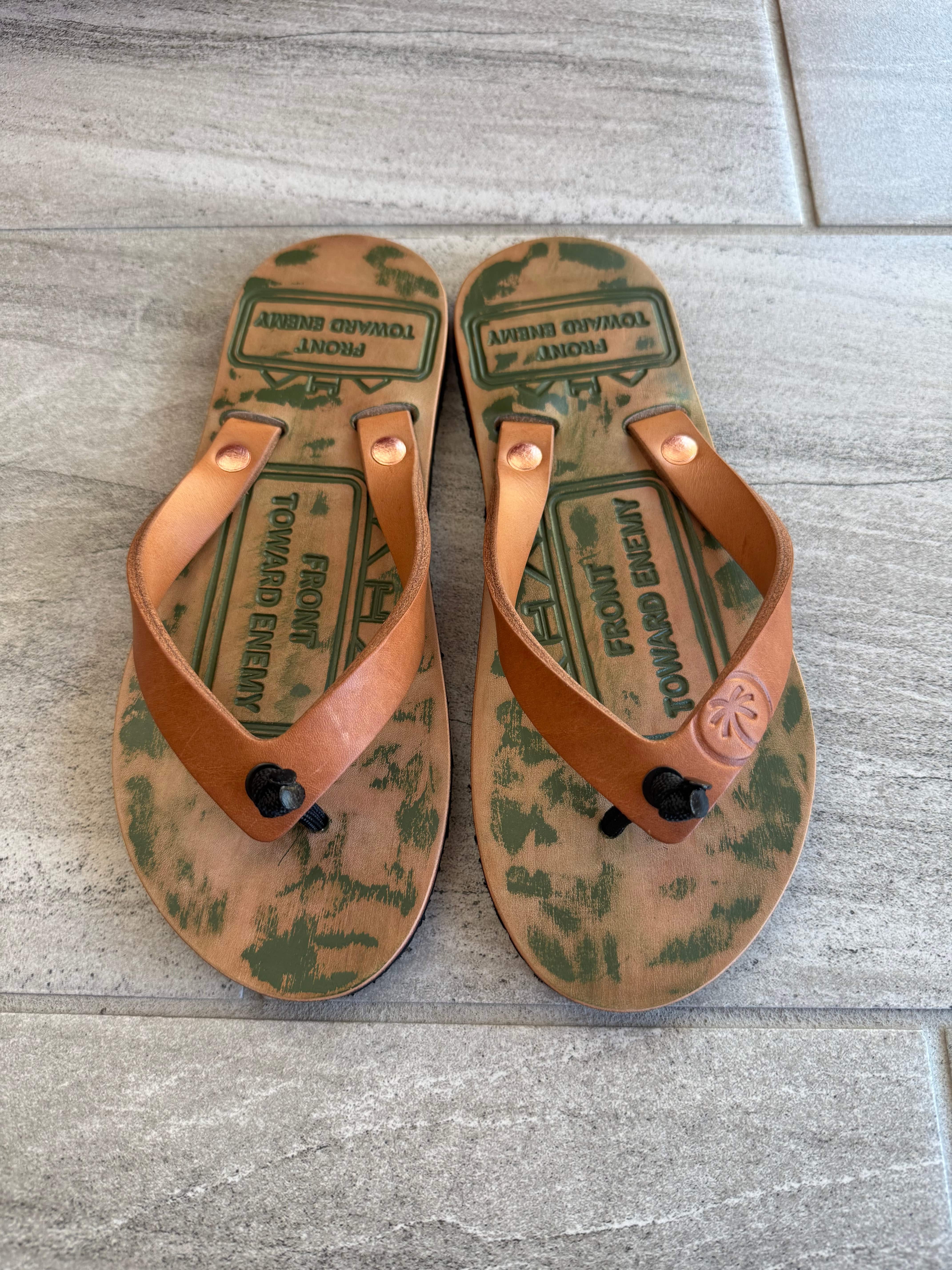 Toehold Claymore flip-flops with black straps and textured soles, showcasing comfortable casual footwear for warm weather.