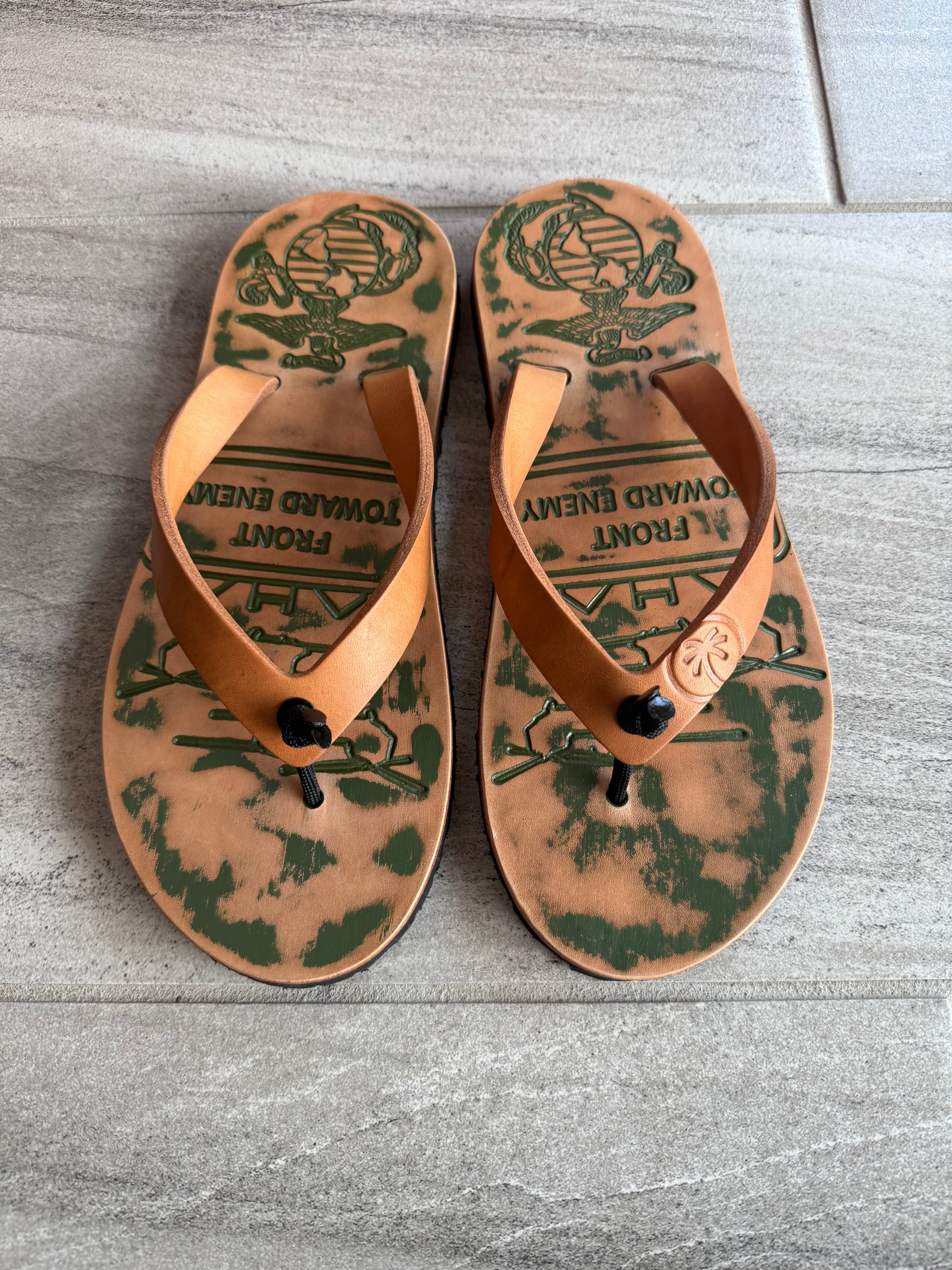 Toehold USMC flip-flops featuring military-inspired design with adjustable straps and durable rubber soles.