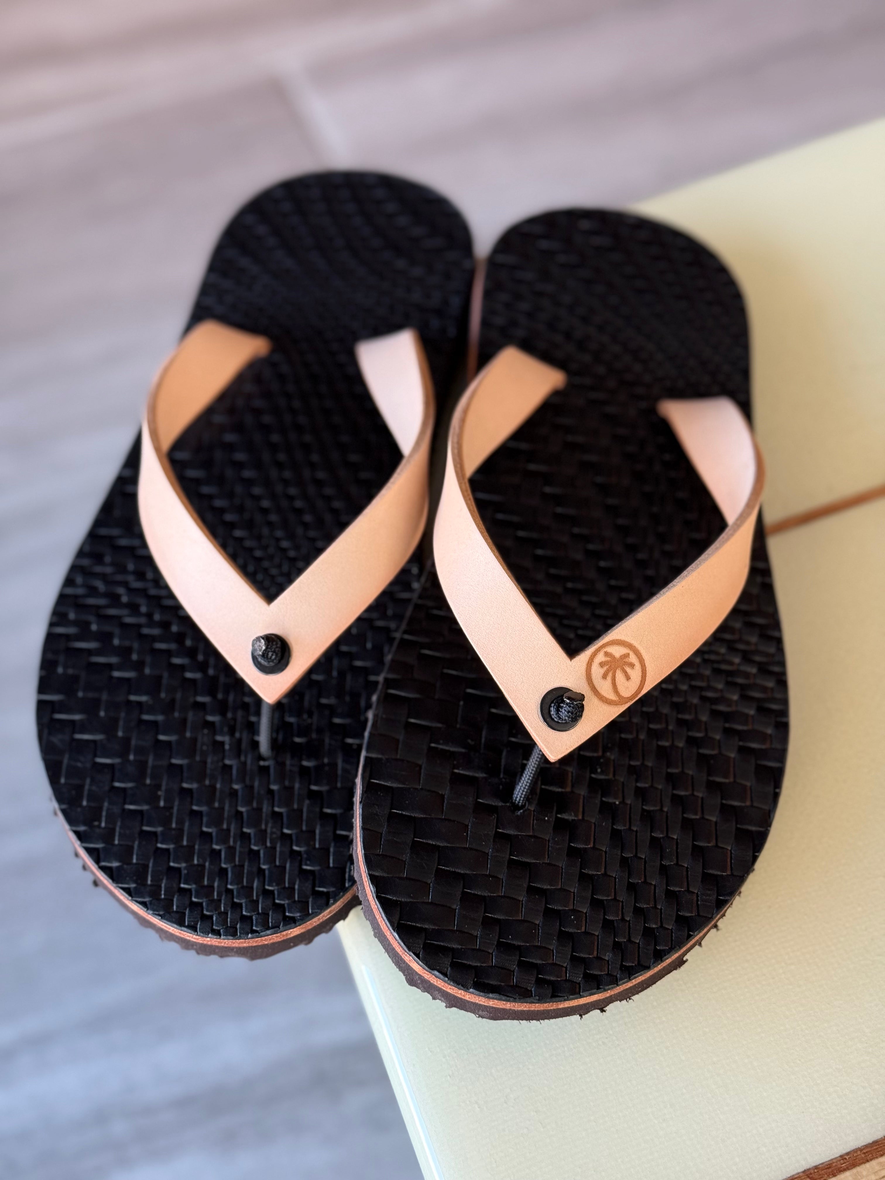Toehold black grenade skin flip-flops with bold, graphic design and comfortable straps, suitable for casual wear.