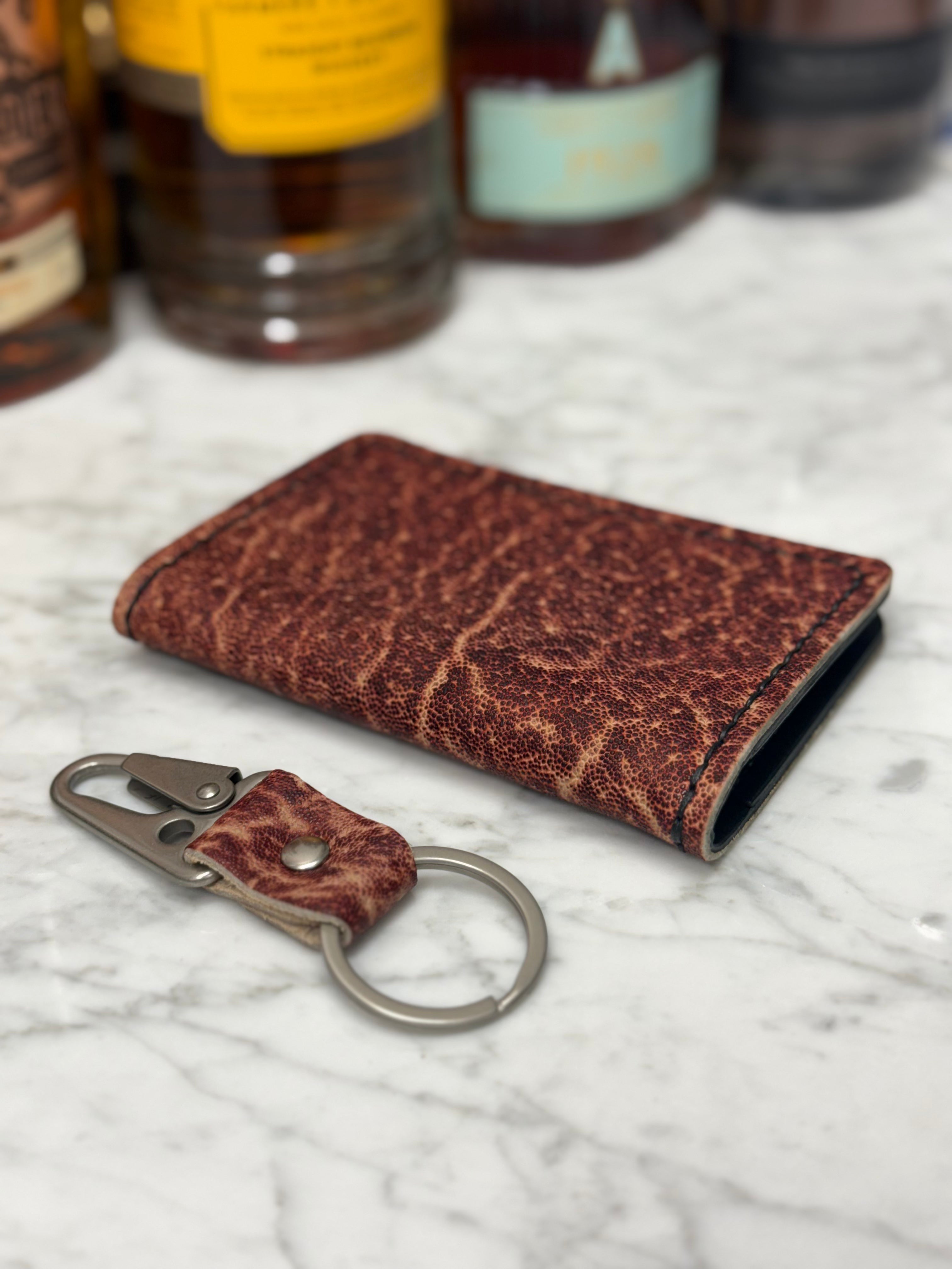 Toehold Man Killing Elephant passport wallet with a detailed embroidered elephant design and multiple card slots.