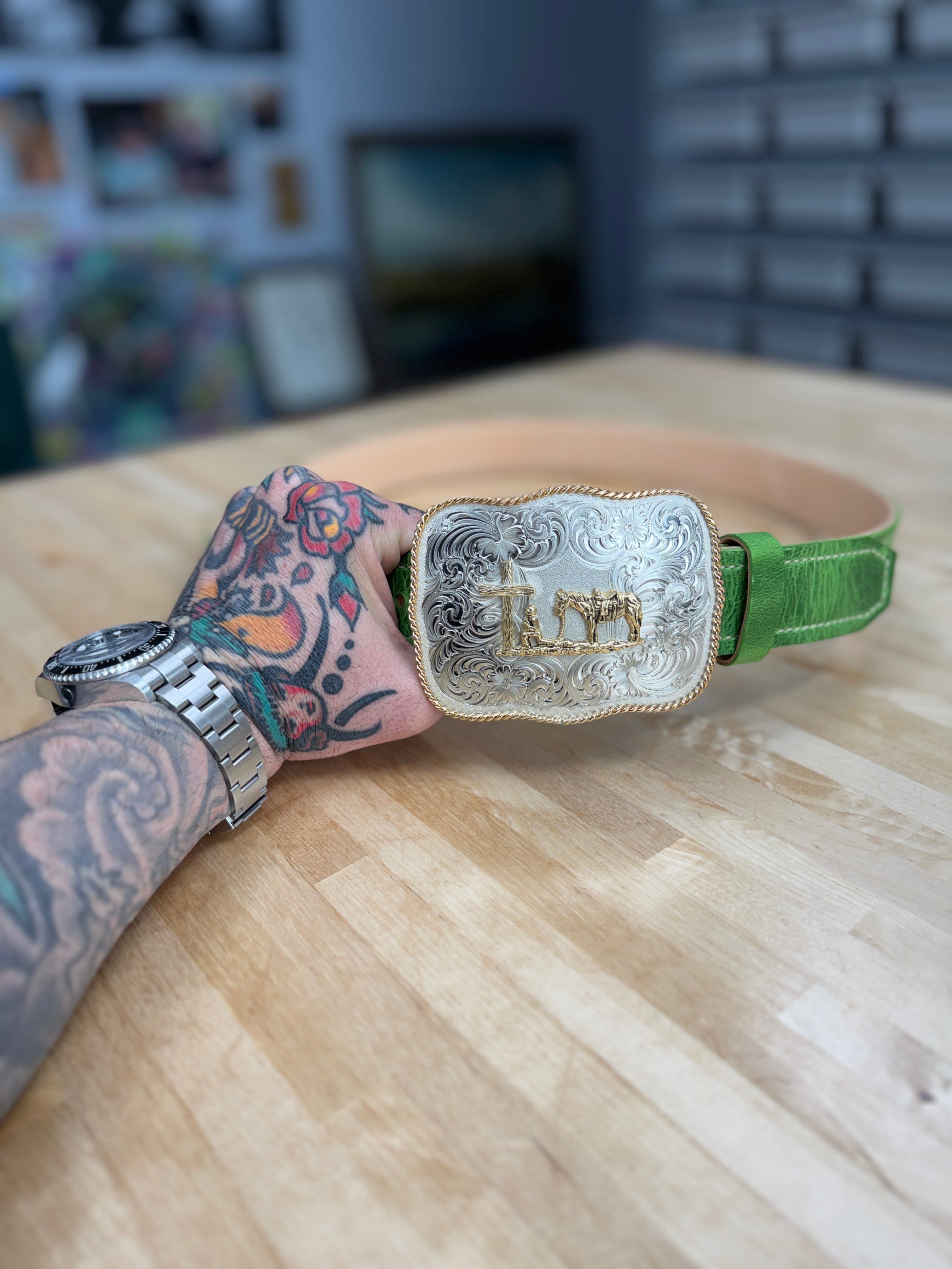 Emerald green cowhide belt from Toehold featuring a polished metal buckle and textured leather finish.