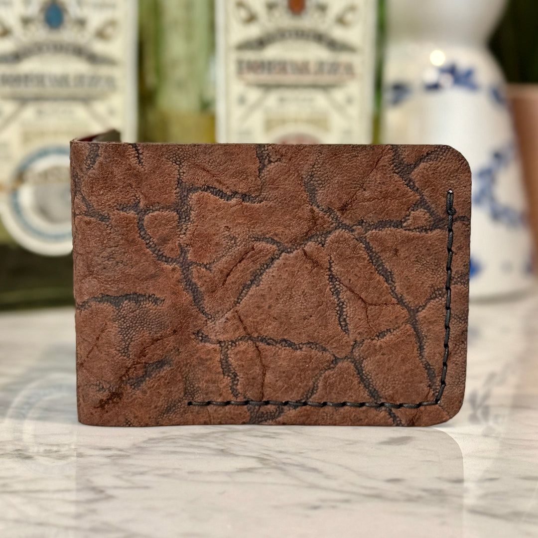 Toehold Elephant Ear Bi-Fold Wallet showing textured leather finish and multiple card slots on a neutral background