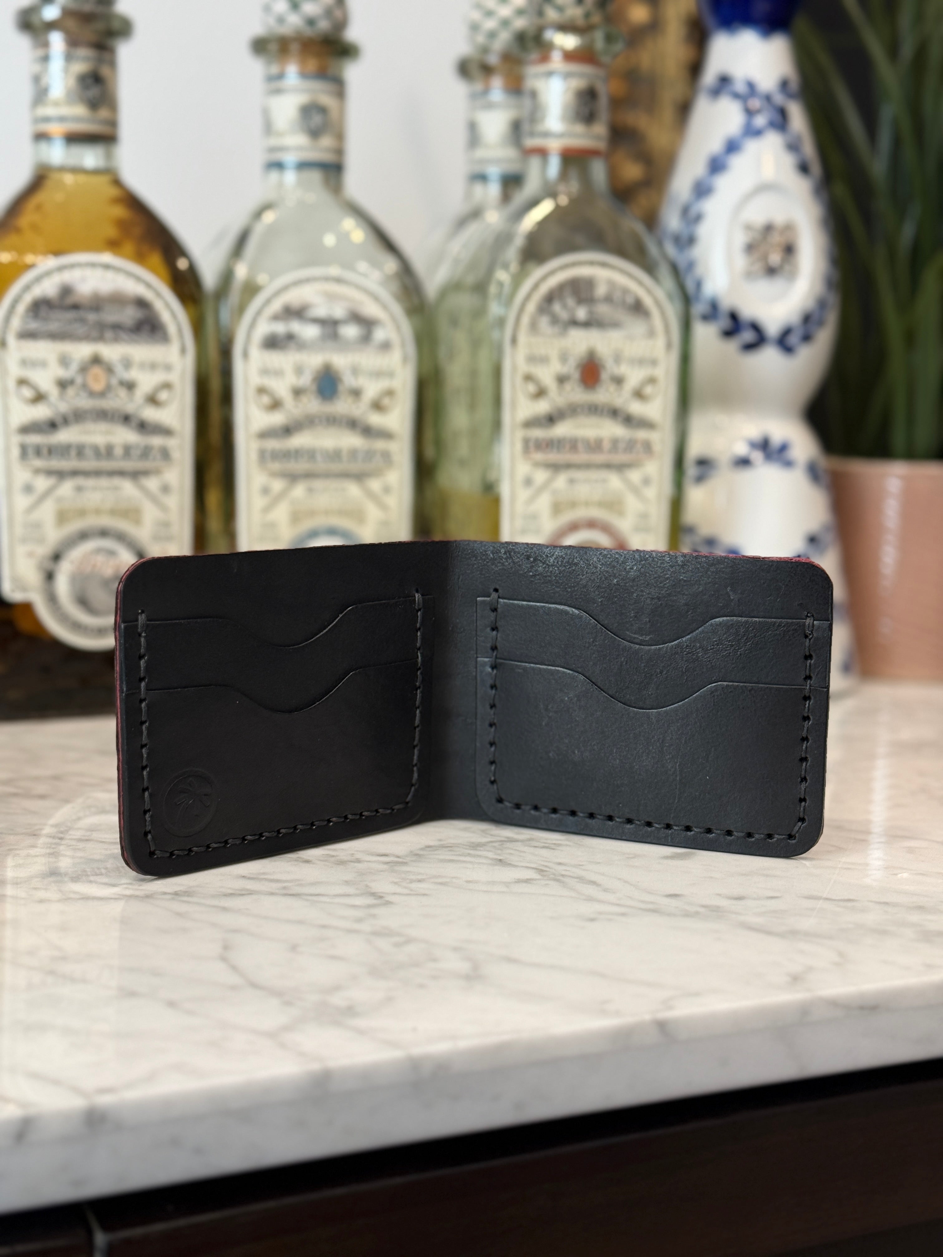 Toehold Elephant Ear Bi-Fold Wallet with textured leather and multiple card slots, shown in a close-up view.