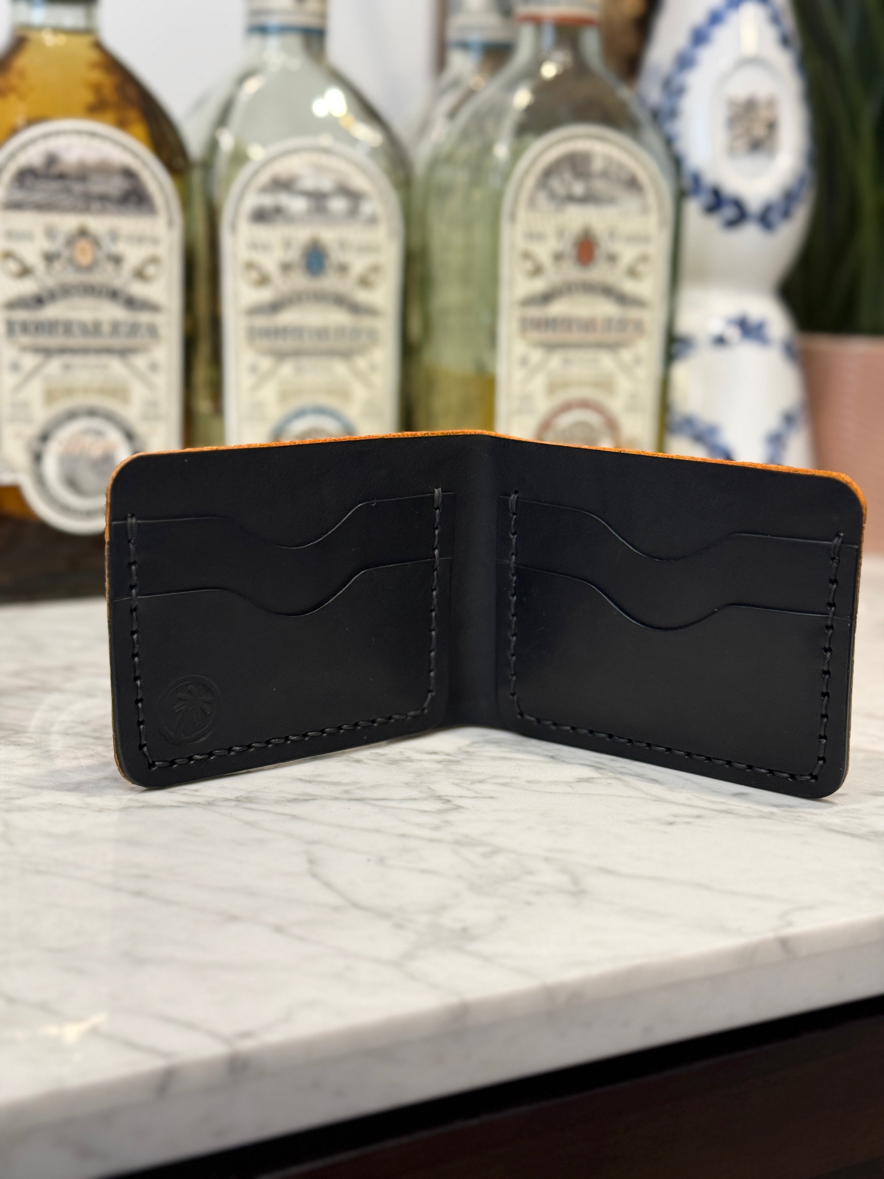 Golden Elephant Toehold bi-fold wallet with embossed elephant design, leather material, and multiple card slots.