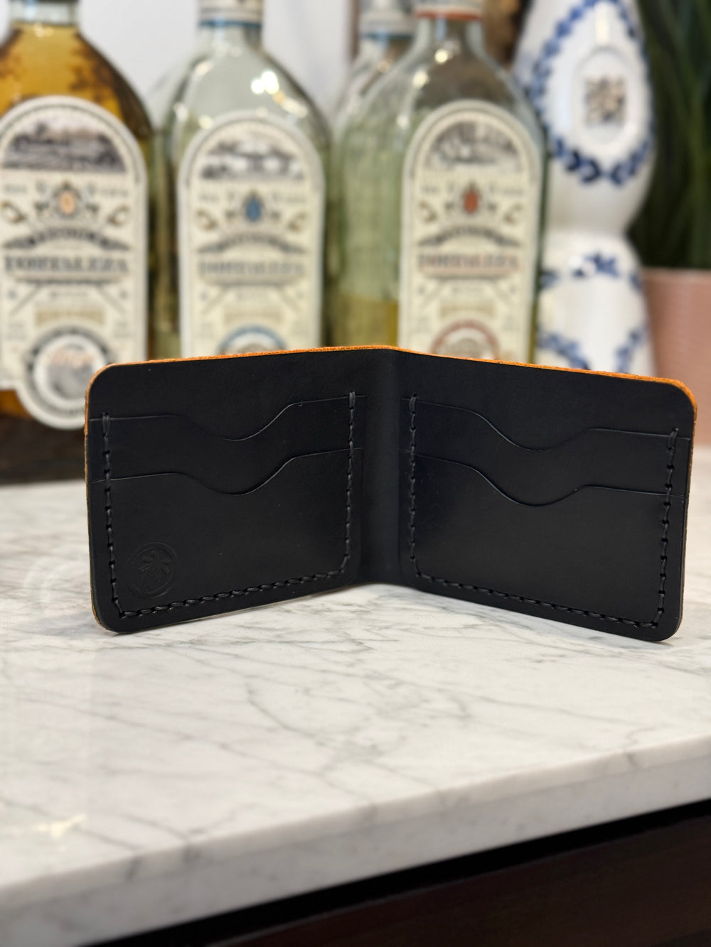 Golden Elephant Toehold bi-fold wallet with embossed elephant design, leather material, and multiple card slots.