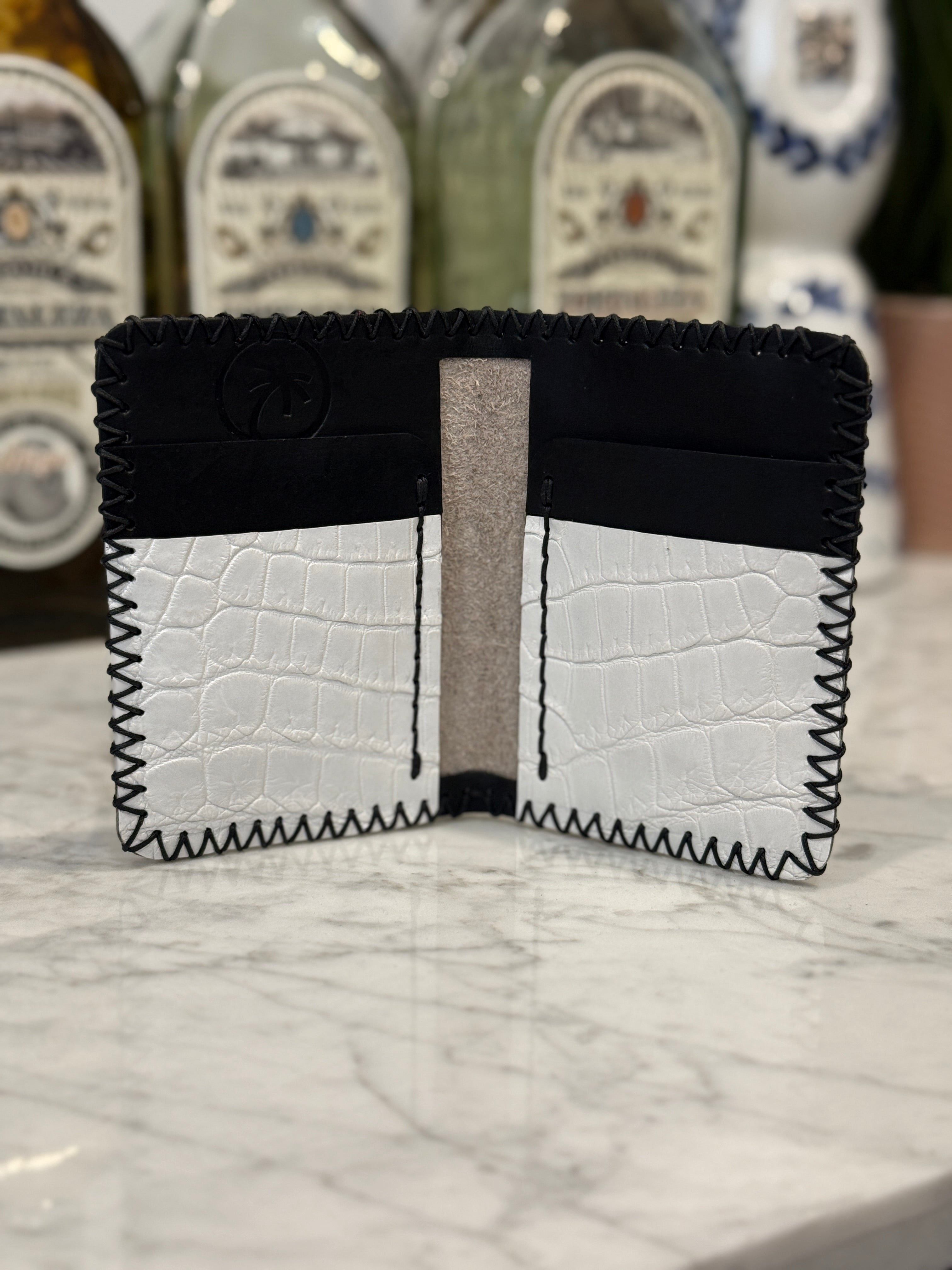 White pressed ostrich leather JW wallet by Toehold with multiple card slots and sleek design.