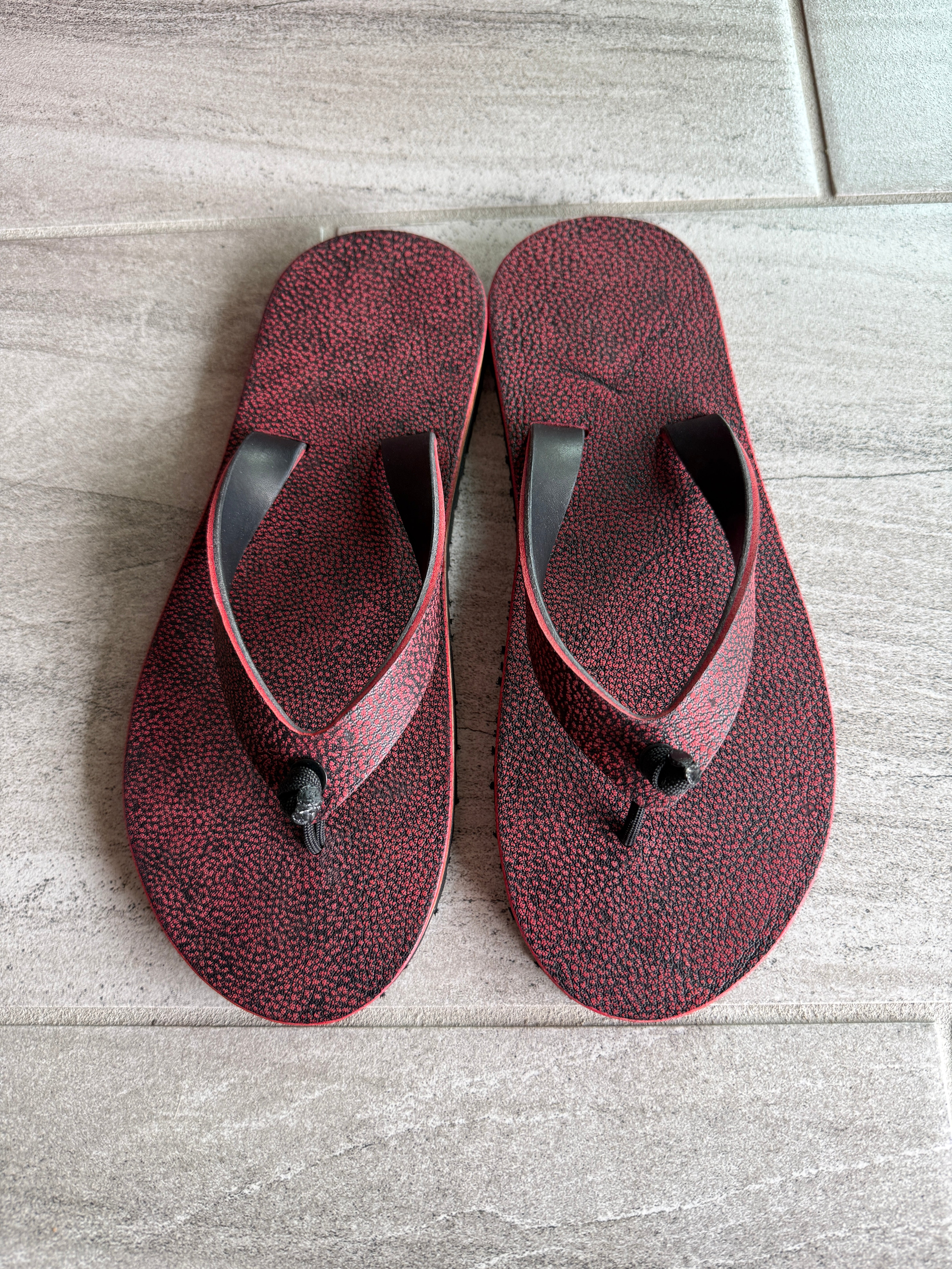 Red Giraffe Toehold flip-flops for women with matching straps, featuring a playful giraffe pattern on comfortable footwear