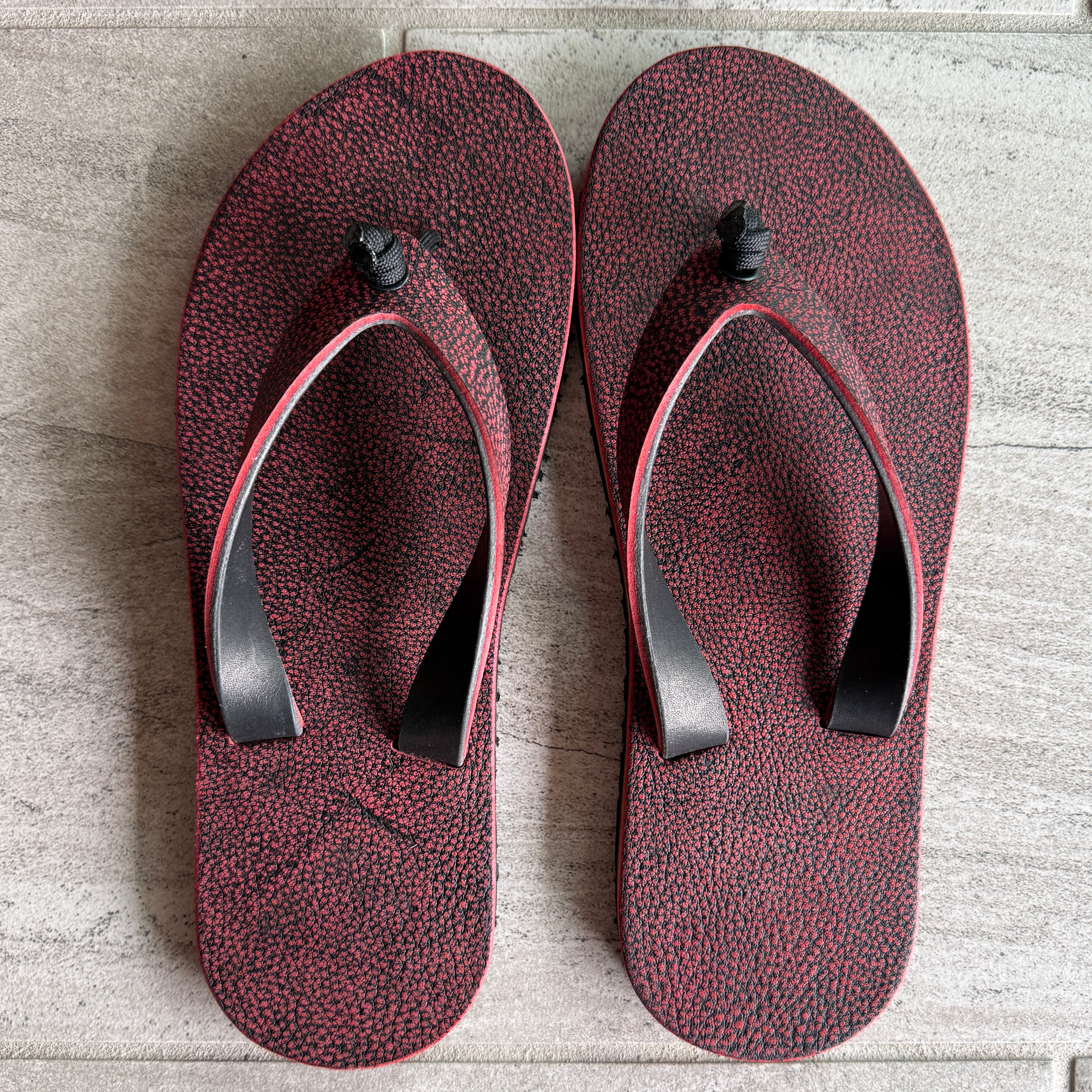 Red Giraffe flip-flops for women by Toehold with matching straps, featuring a playful giraffe print and comfortable open-toe design.