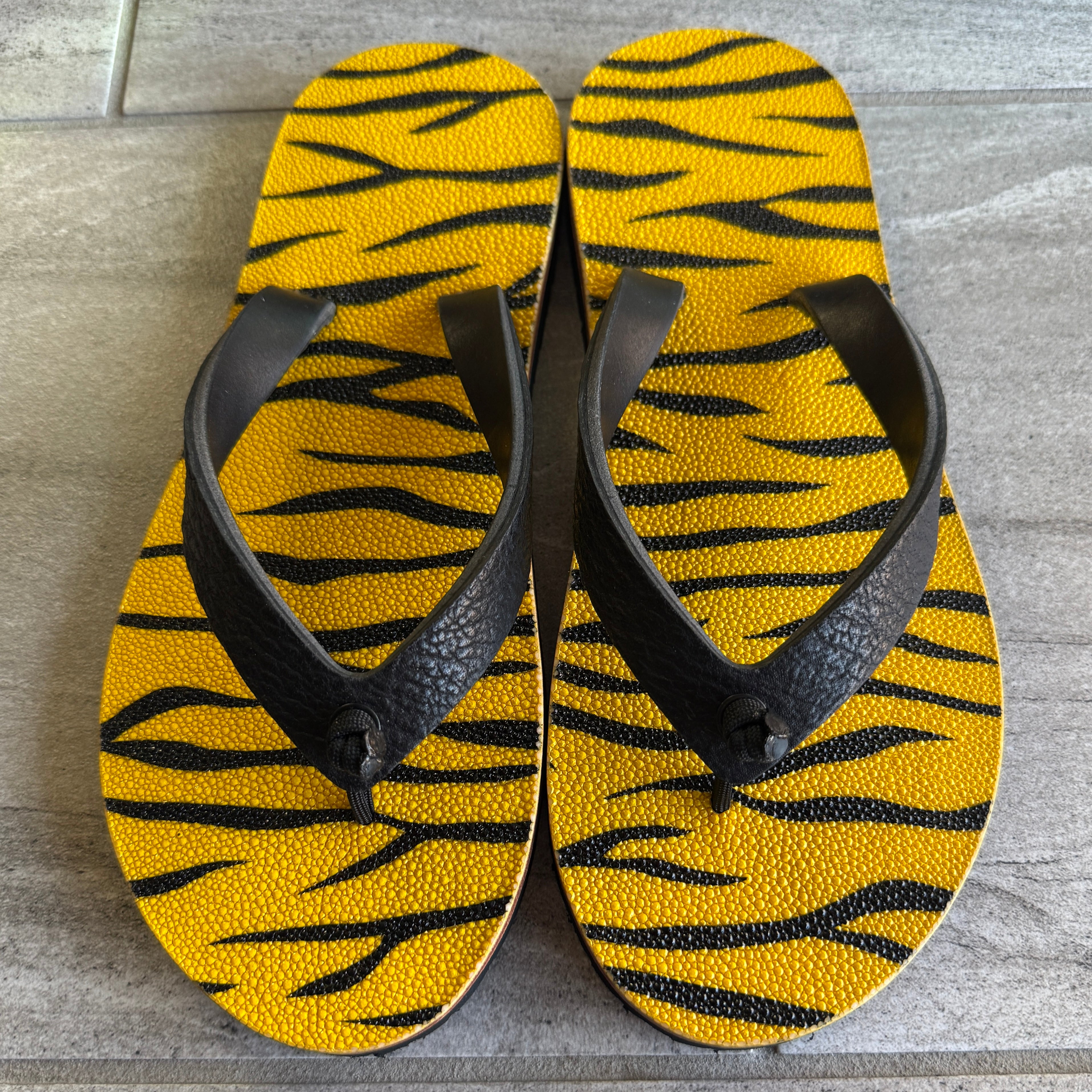 Black Toehold Electric Stingray women's sandal with elephant strap design, featuring a sleek, modern style.